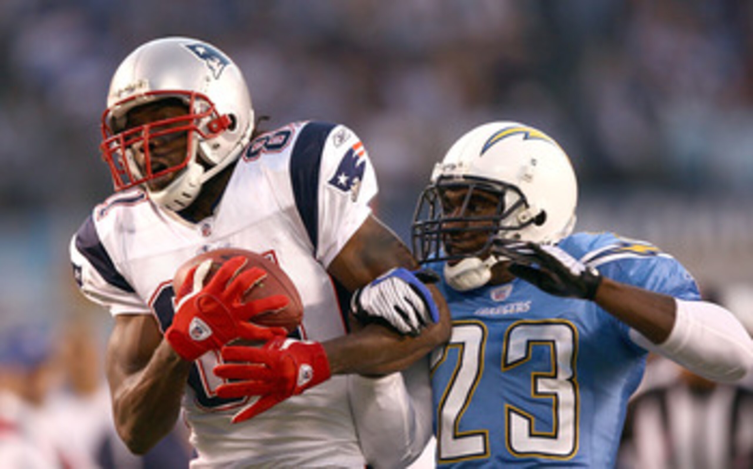 SAN DIEGO - OCTOBER 12:  Wide Receiver Randy Moss #81 of the New England Patriots can't hold onto a pass against Cornerback Quentin Jammer #23 of the San Diego Chargers during the first half of their NFL Game on October 12, 2008 at Qualcomm Stadium in San
