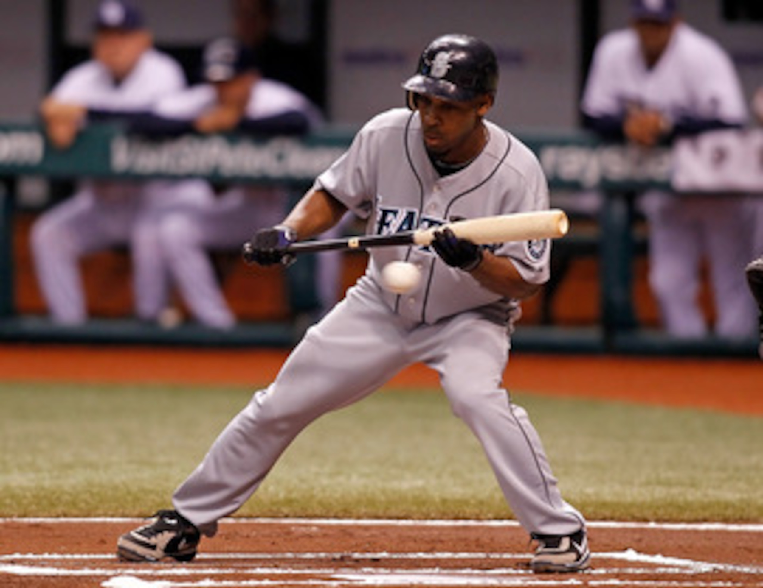 ST. PETERSBURG - SEPTEMBER 24:  Infielder Chone Figgins #9 of the Seattle Mariners attempts a bunt against the Tampa Bay Rays during the game at Tropicana Field on September 24, 2010 in St. Petersburg, Florida.  (Photo by J. Meric/Getty Images)