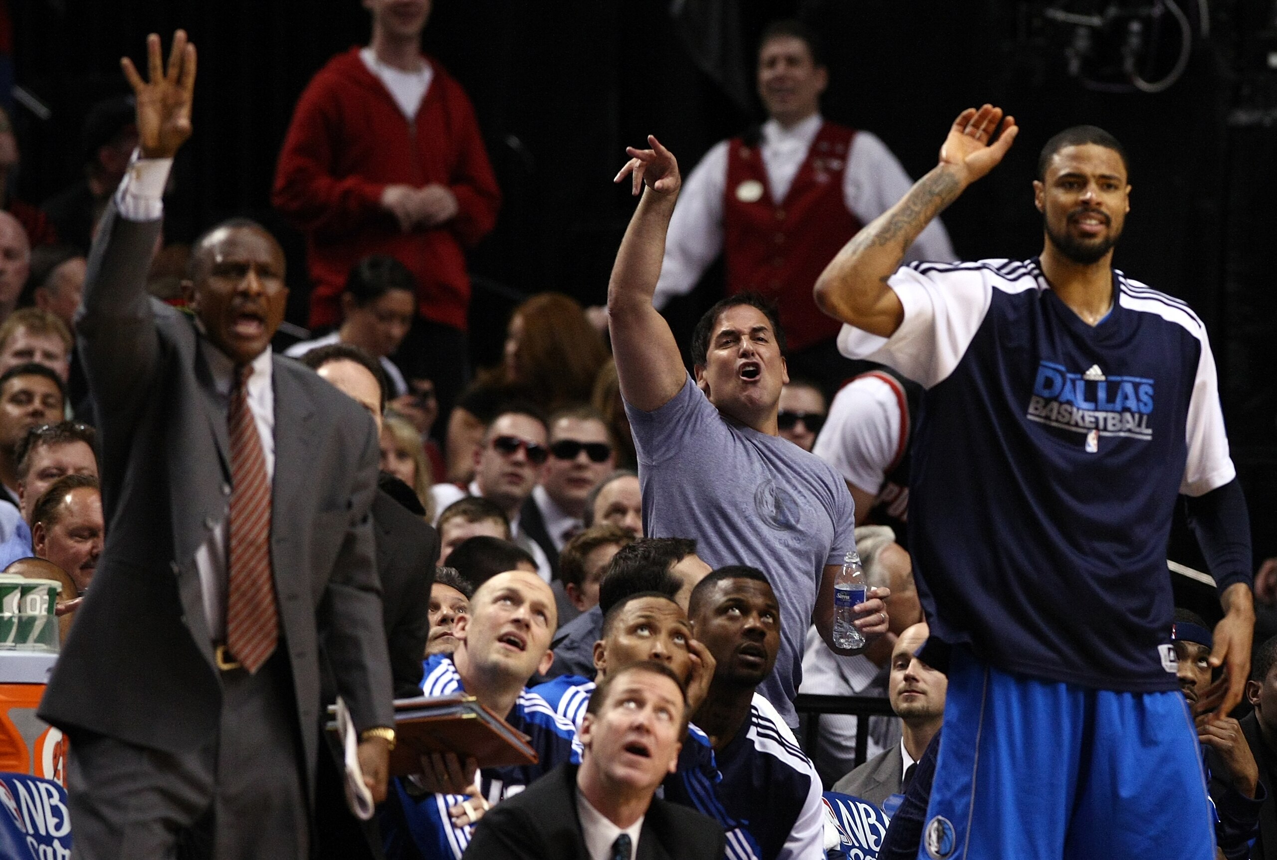 PORTLAND, OR - APRIL 21:  Dallas Mavericks owner, Mark Cuban (C), Tyson Chandler #6 (R) and assistant coach  Dwayne Casey (L) call for a shooting foul against the Portland Trail Blazersin Game Three of the Western Conference Quarterfinals in the 2011 NBA