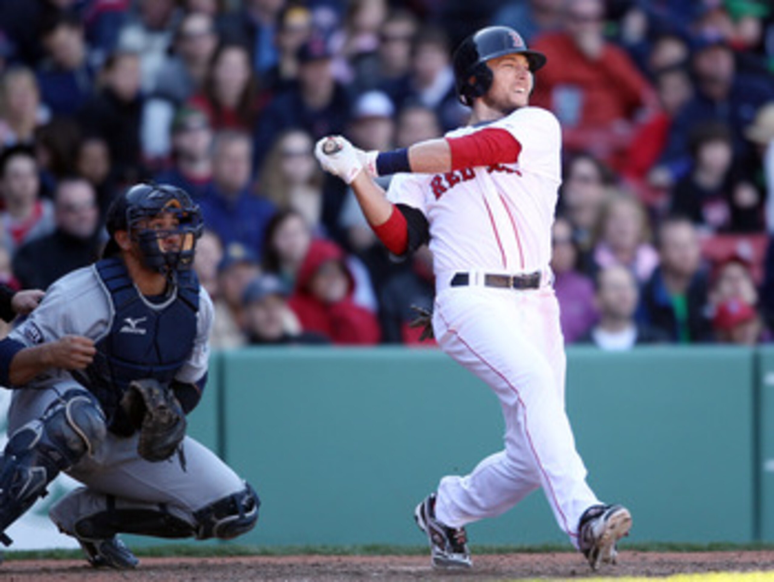 BOSTON, MA - MAY 01:  Jed Lowrie #12 of the Boston Red Sox hits a triple in the bottom of the ninth inning against the Seattle Mariners Miguel Olivo #30 of the Seattle Mariners catches on May 1, 2011 at Fenway Park in Boston, Massachusetts. The Boston Red
