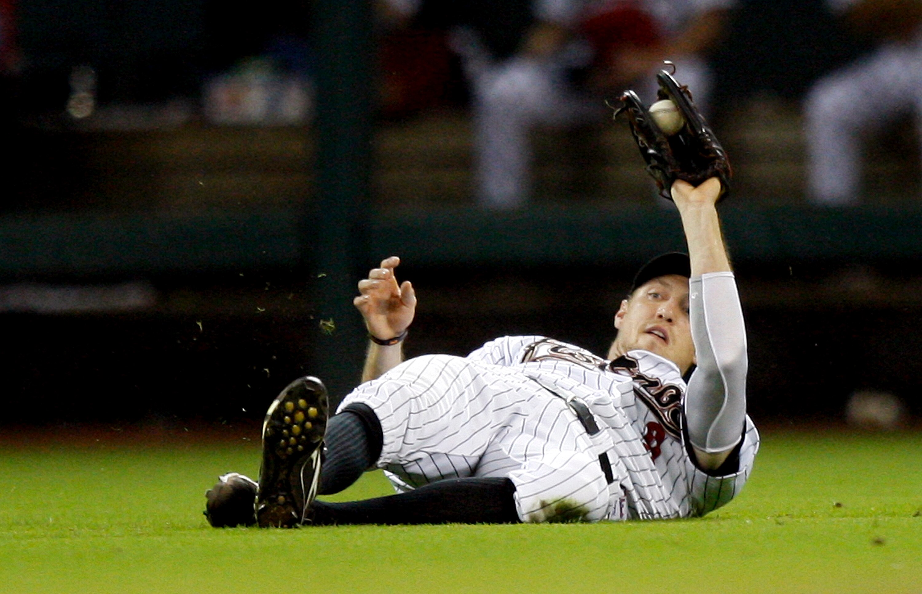 HOUSTON - AUGUST 19:  Left fielder Hunter Pence #9 of the Houston Astros makes a sliding save on a short fly ball hit by Jeff Francoeur of the New York Mets at Minute Maid Park on August 19, 2010 in Houston, Texas. Houston won 3-2.  (Photo by Bob Levey/Ge
