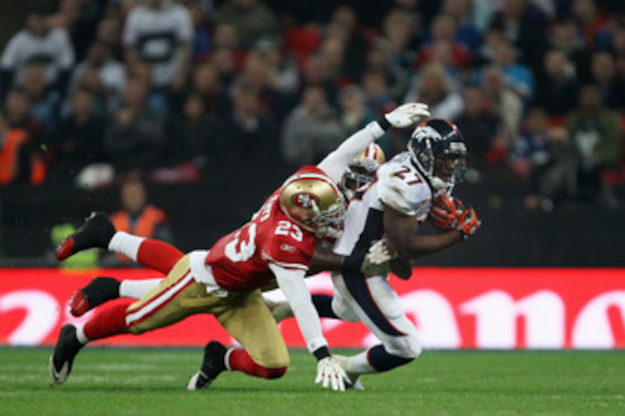 LONDON, ENGLAND - OCTOBER 31:  Knowshon Moreno #27 of Denver Broncos is tackled by Taylor Mays #23 of San Francisco 49ers during the NFL International Series match between Denver Broncos and San Francisco 49ers at Wembley Stadium on October 31, 2010 in Lo
