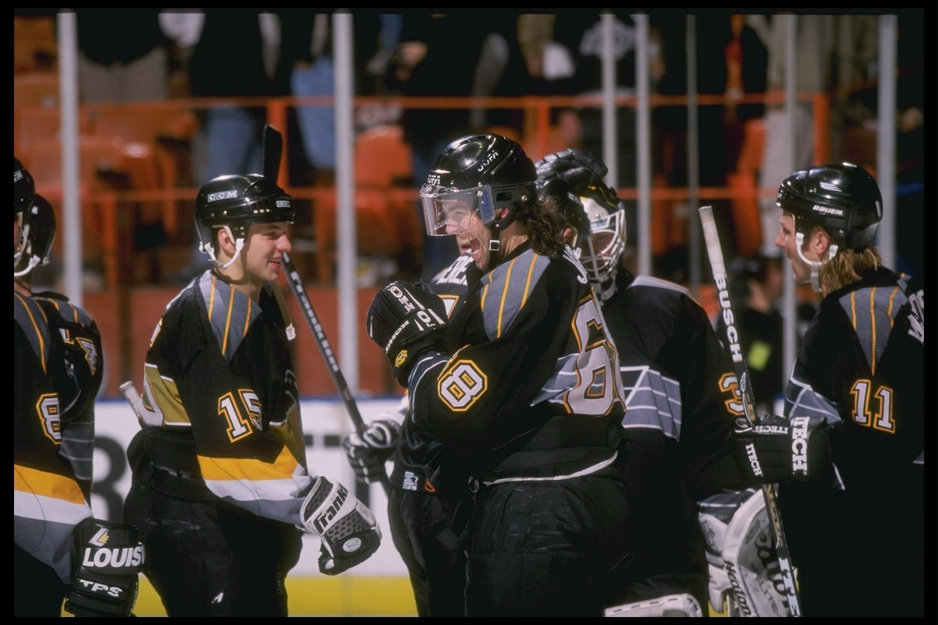 9 Dec 1997:  Right winger Jaromir Jagr of the Pittsburgh Penguins talks to teammate Robert Dome (center) during a game against the Los Angeles Kings at the Great Western Forum in Inglewood, California.  The Penguins won the game 2-1. Mandatory Credit: Els