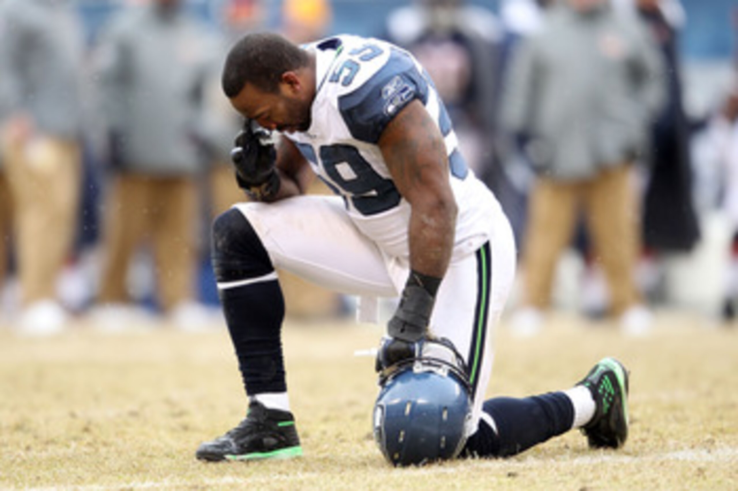 CHICAGO, IL - JANUARY 16: Aaron Curry #59 of the Seattle Seahawks prays as teammate Marcus Trufant #23 is injured on the field in the third quarter against the Chicago Bears in the 2011 NFC divisional playoff game at Soldier Field on January 16, 2011 in CHICAGO, IL - JANUARY 16: Aaron Curry #59 of the Seattle Seahawks prays as teammate Marcus Trufant #23 is injured on the field in the third quarter against the Chicago Bears in the 2011 NFC divisional playoff game at Soldier Field on January 16, 2011 in