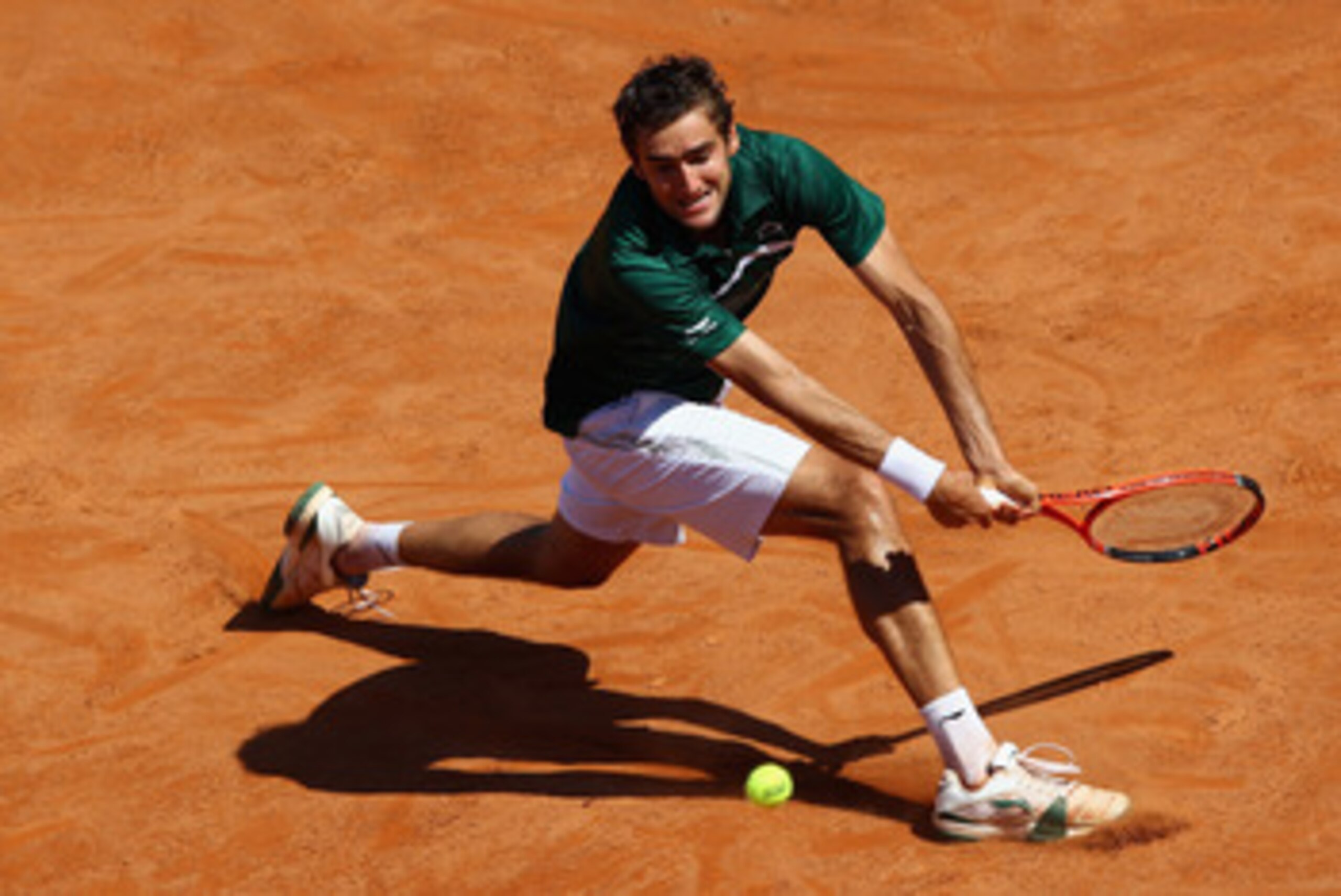 ROME, ITALY - MAY 13:  Marin Cilic of Croatia slides to play a backhand during his quarter final match against Rafael Nadal of Spain during day six of the Internazoinali BNL D'Italia at the Foro Italico Tennis Centre  on May 13, 2011 in Rome, Italy.  (Pho