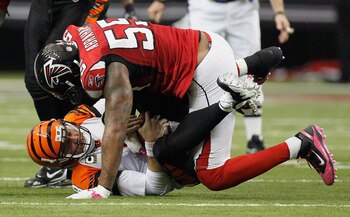 ATLANTA - OCTOBER 24:  Quarterback Carson Palmer #9 of the Cincinnati Bengals is sacked by John Abraham #55 of the Atlanta Falcons at Georgia Dome on October 24, 2010 in Atlanta, Georgia.  (Photo by Kevin C. Cox/Getty Images)