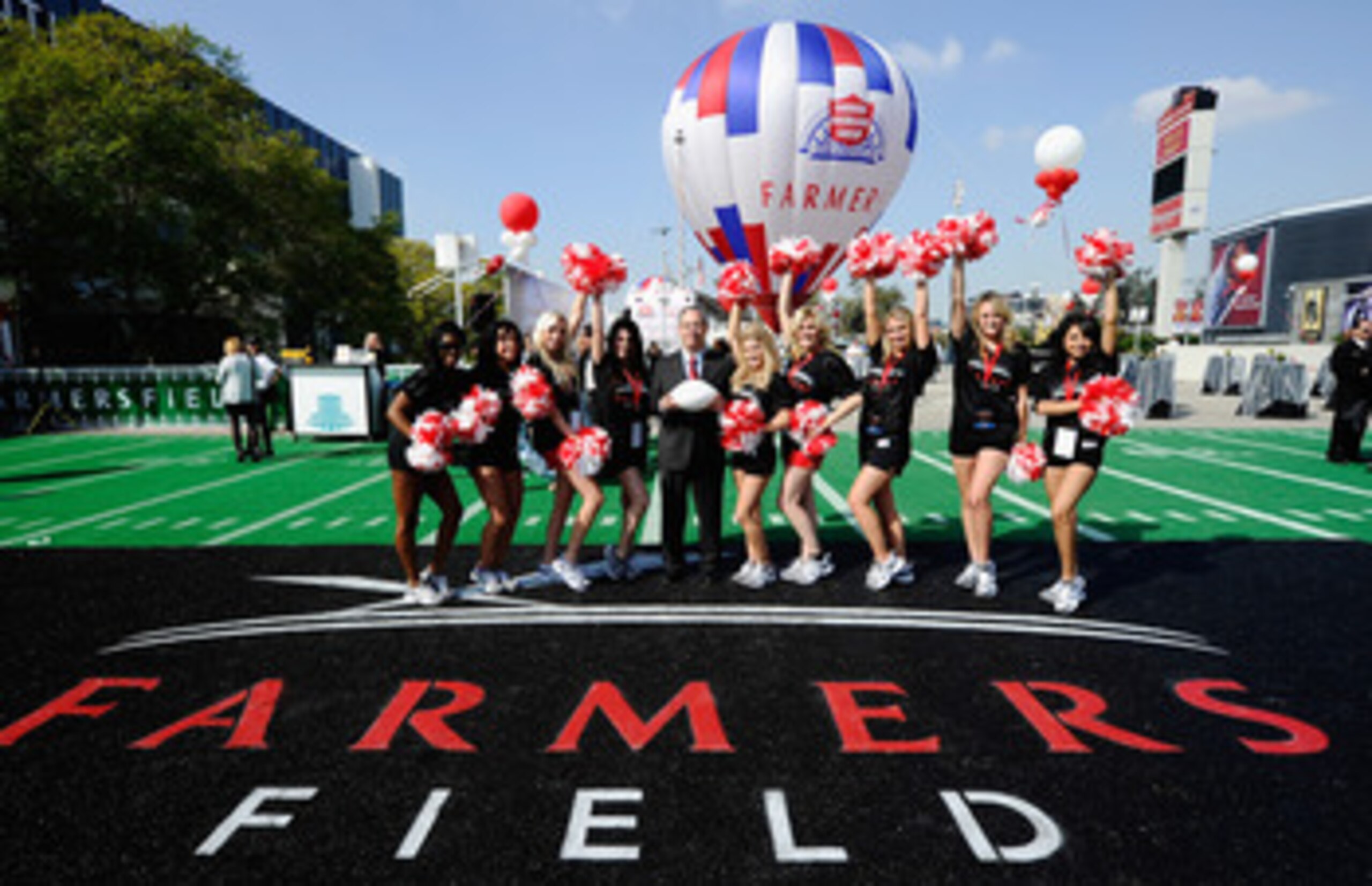 LOS ANGELES, CA - FEBRUARY 01:  Farmers Insurance Exchange executives Paul Patsis (C) with cheerleaders after an event announcing naming rights for the new football stadium Farmers Field at Los Angeles Convention Center on February 1, 2011 in Los Angeles,