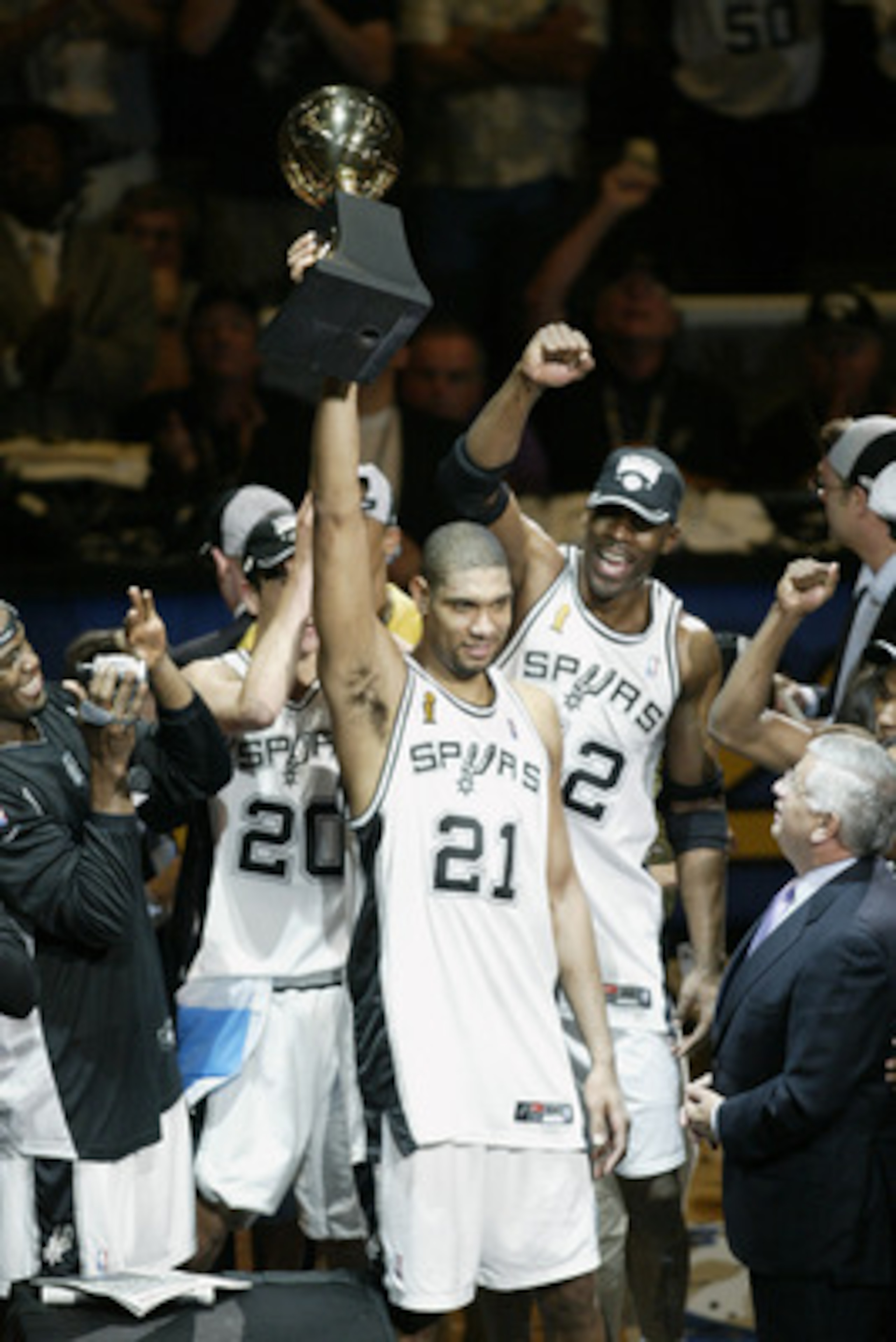 SAN ANTONIO - JUNE 15:  Tim Duncan #21 of the San Antonio Spurs holds up his 2003 NBA Finals MVP (Most Valuable Player) award as the San Antonio Spurs celebrate their NBA Championship after defeating the New Jersey Nets in game six of the 2003 NBA Finals