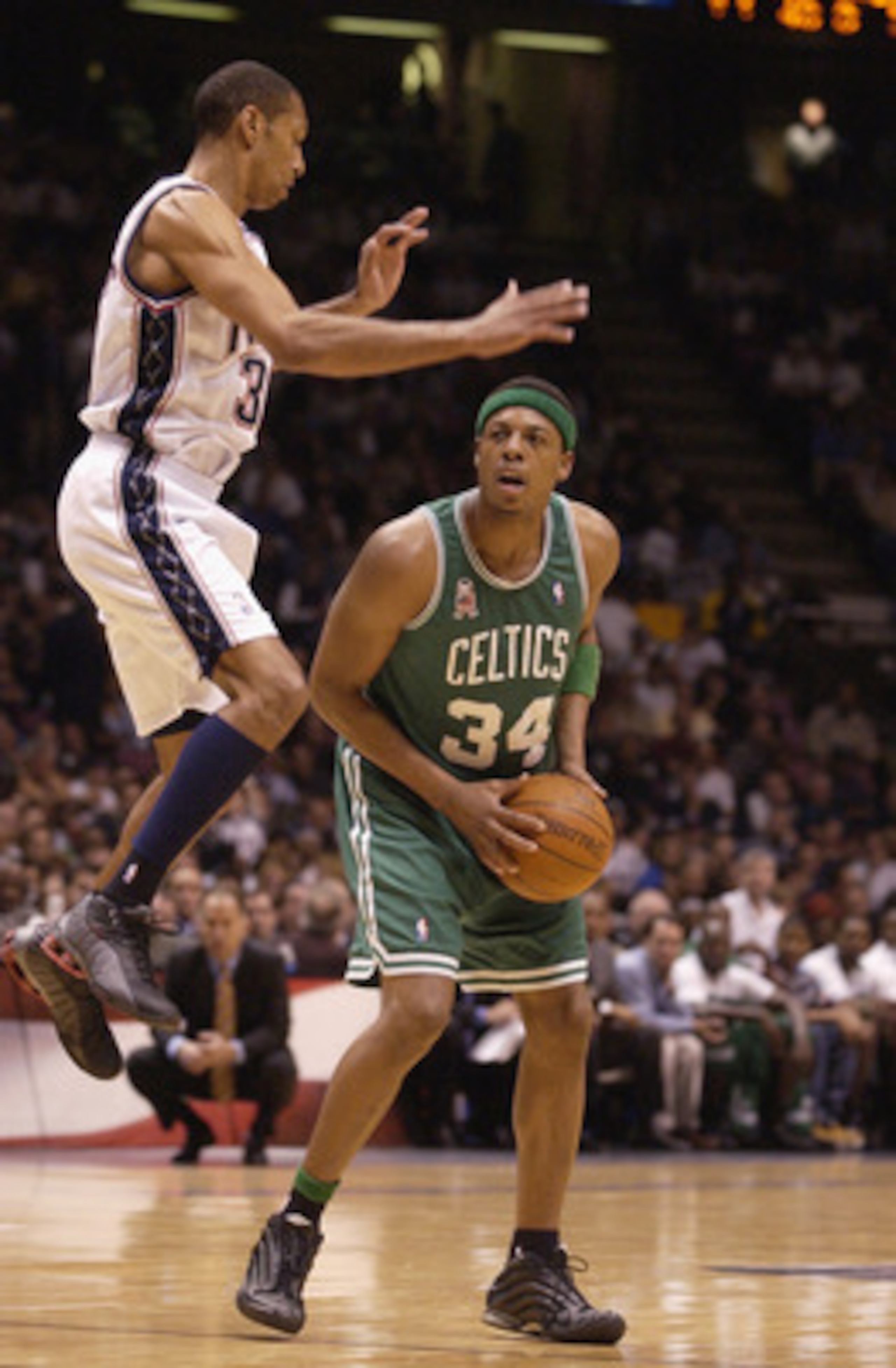 EAST RUTHERFORD, NJ - MAY 21: Paul Pierce #34 of the Boston Celtics avoids Kerry Kittles #30 of the New Jersey Nets in Game two of the Eastern Conference Finals during the 2002 NBA Playoffs at Continental Airlines Arena in East Rutherford, New Jersey on M