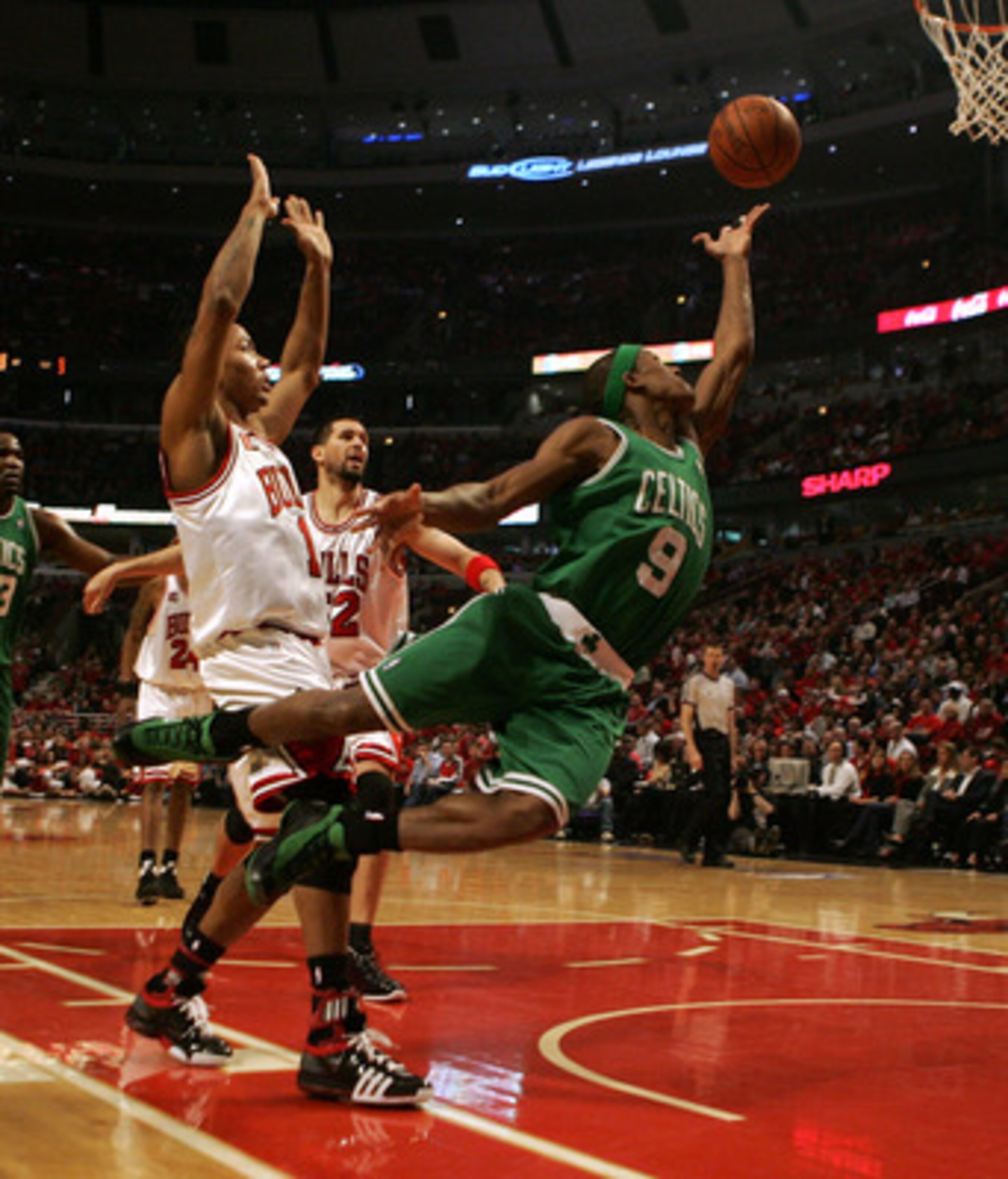 CHICAGO - APRIL 30: Rajon Rondo #9 of the Boston Celtics puts up a shot past Derrick Rose #1 and Brad Miller #52 of the Chicago Bulls in Game Six of the Eastern Conference Quarterfinals during the 2009 NBA Playoffs at the United Center on April 30, 2009 i