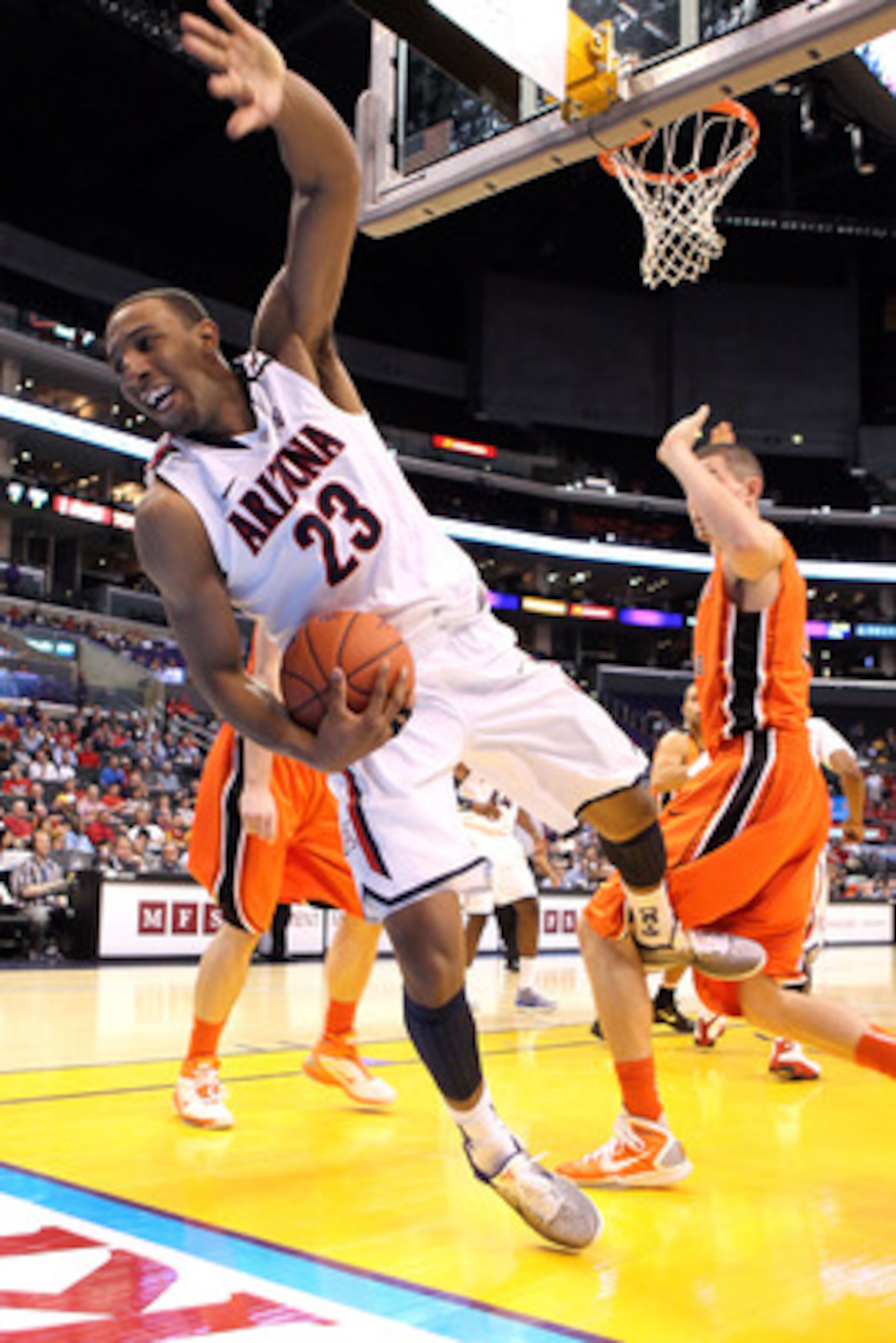 LOS ANGELES, CA - MARCH 10:  Derrick Williams #23 of the Arizona Wildcats attempts to not fall out of bounds with the ball against the Oregon State Beavers in the quarterfinals of the 2011 Pacific Life Pac-10 Men's Basketball Tournament at Staples Center 