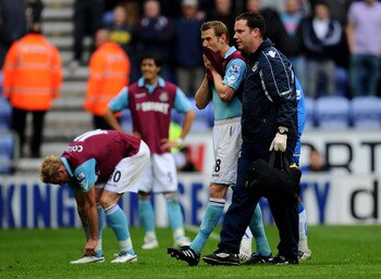 WIGAN, ENGLAND - MAY 15:  Jonathan Spector of West Ham United looks dejected following his team's relegation at the end of the Barclays Premier League match between Wigan Athletic and West Ham United at the DW Stadium on May 15, 2011 in Wigan, England.  (