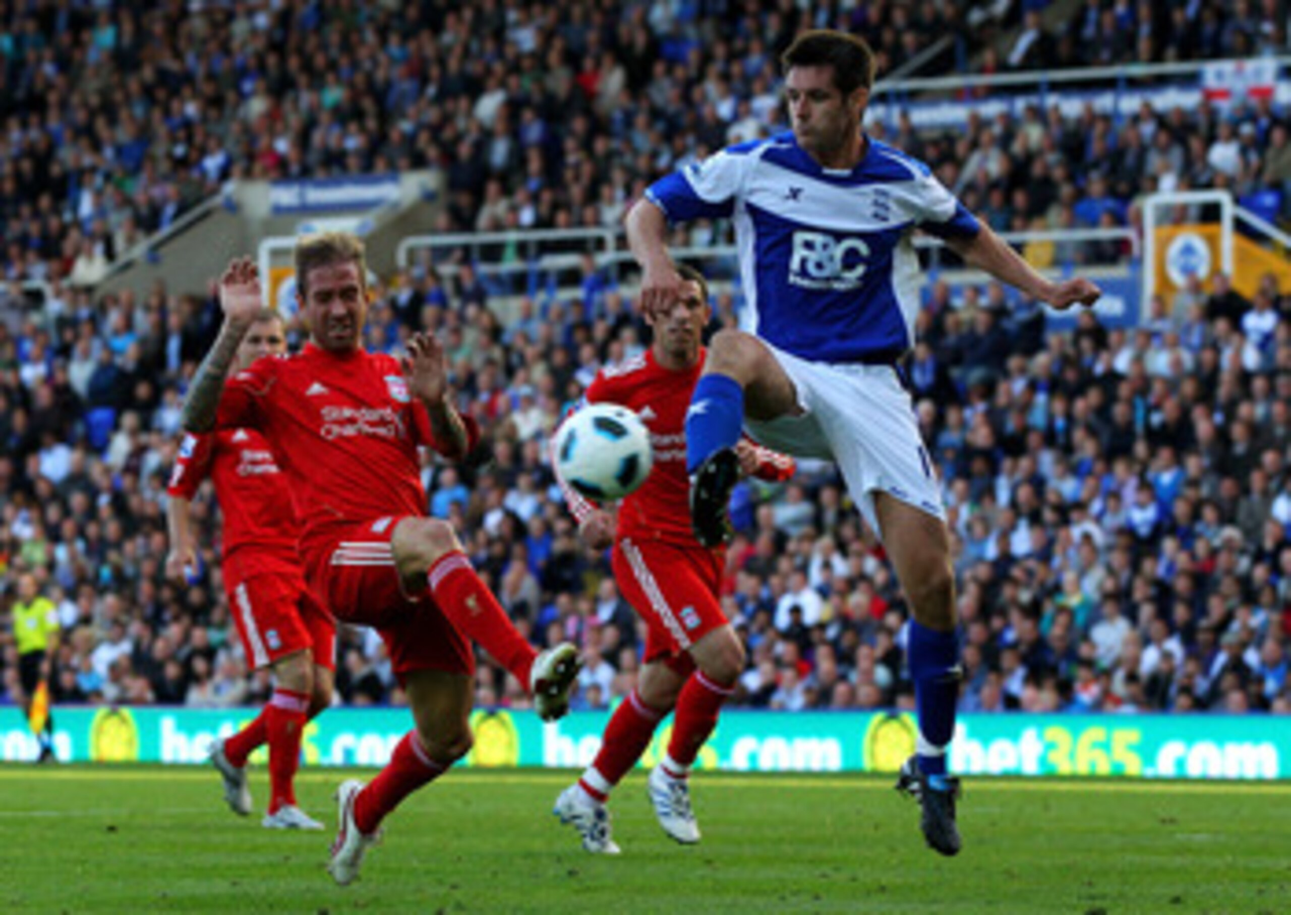 BIRMINGHAM, ENGLAND - SEPTEMBER 12:  Raul Meireles of Liverpool challenges Scott Dann of Birmingham City during the Barclays Premier League match between Birmingham City and Liverpool at St Andrew's Stadium on September 12, 2010 in Birmingham, England. (P