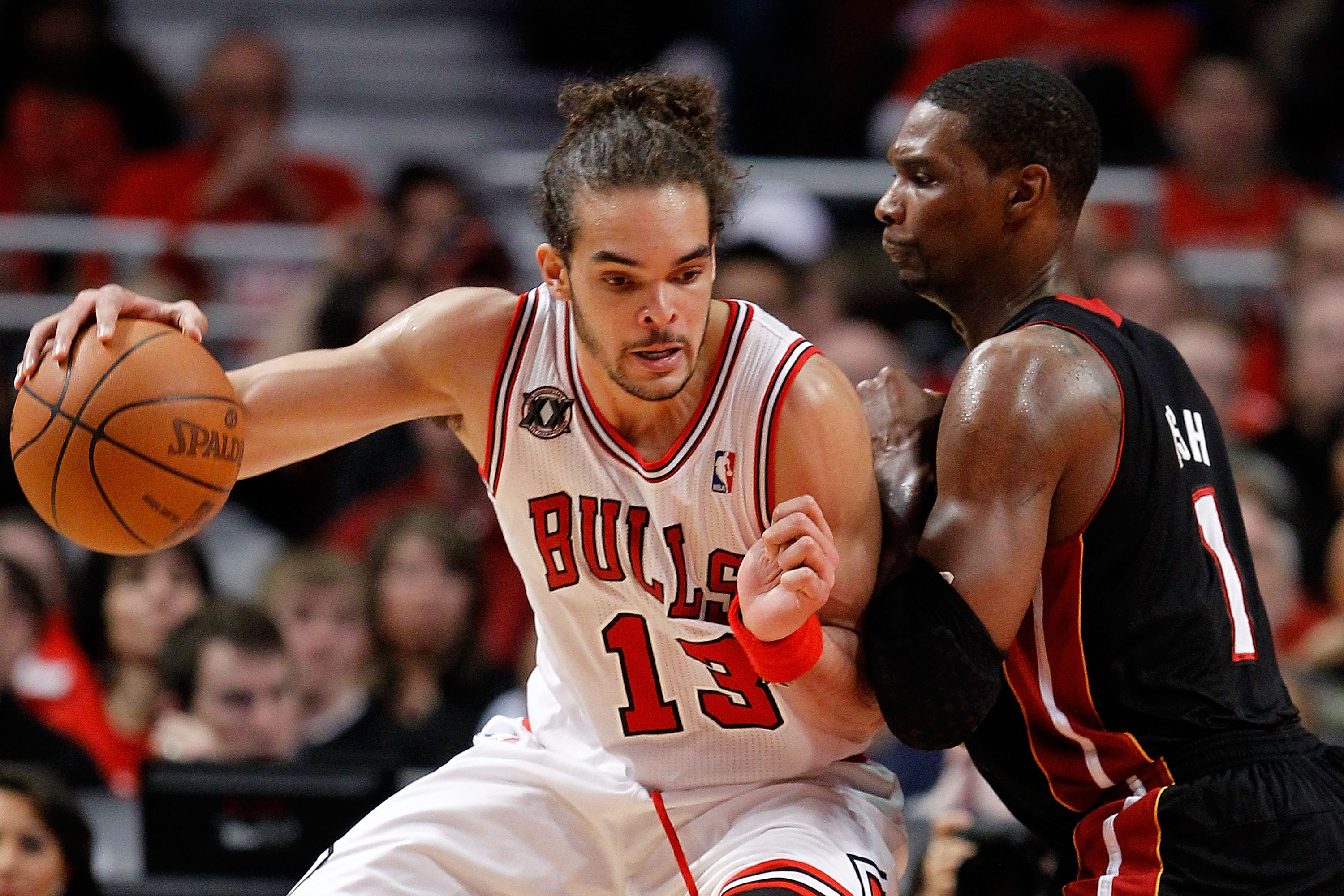 CHICAGO, IL - MAY 15:  Joakim Noah #13 of the Chicago Bulls drives against Chris Bosh #1 of the Miami Heat in Game One of the Eastern Conference Finals during the 2011 NBA Playoffs on May 15, 2011 at the United Center in Chicago, Illinois. The Bulls won 1