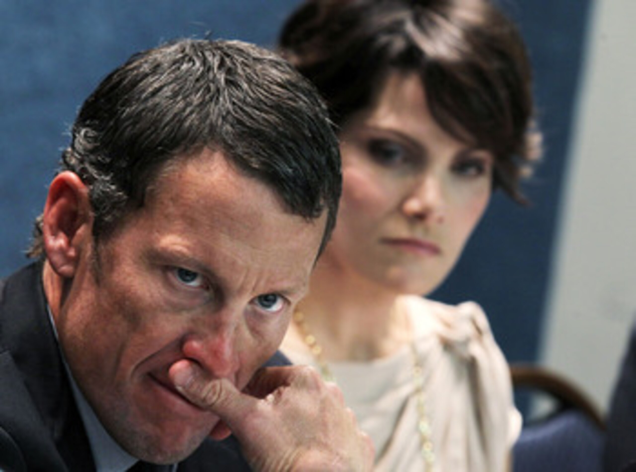 WASHINGTON, DC - MARCH 24: LIVESTRONG Founder and Chairman and seven-time Tour de France champion Lance Armstrong (L) and cancer survivor Tracy Elliman (R) of Kennett Square, Pennsylvania, listen during a news conference at the National Press Club March WASHINGTON, DC - MARCH 24: LIVESTRONG Founder and Chairman and seven-time Tour de France champion Lance Armstrong (L) and cancer survivor Tracy Elliman (R) of Kennett Square, Pennsylvania, listen during a news conference at the National Press Club March