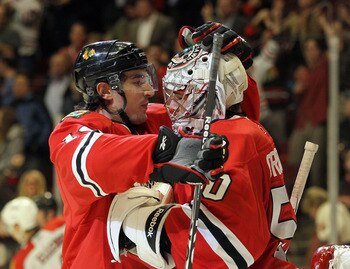 CHICAGO, IL - MARCH 23: Chris Campoli #14 and Corey Crawford #50 of the Chicago Blackhawks celebrate their win over the Florida Panthers at the United Center on March 23, 2011 in Chicago, Illinois. The Blackhawks defeated the Panthers 4-0.  (Photo by Bruc