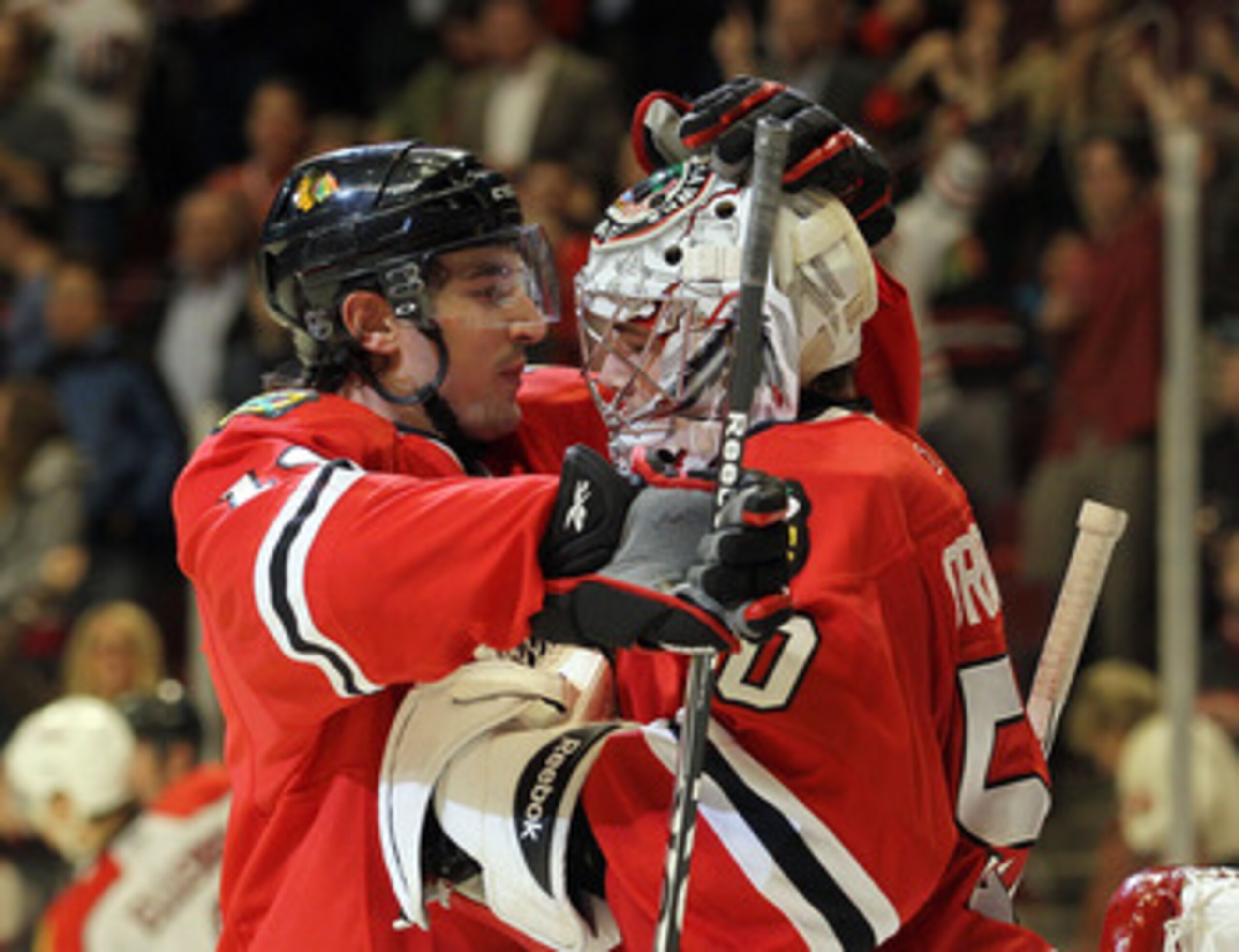 CHICAGO, IL - MARCH 23: Chris Campoli #14 and Corey Crawford #50 of the Chicago Blackhawks celebrate their win over the Florida Panthers at the United Center on March 23, 2011 in Chicago, Illinois. The Blackhawks defeated the Panthers 4-0.  (Photo by Bruc