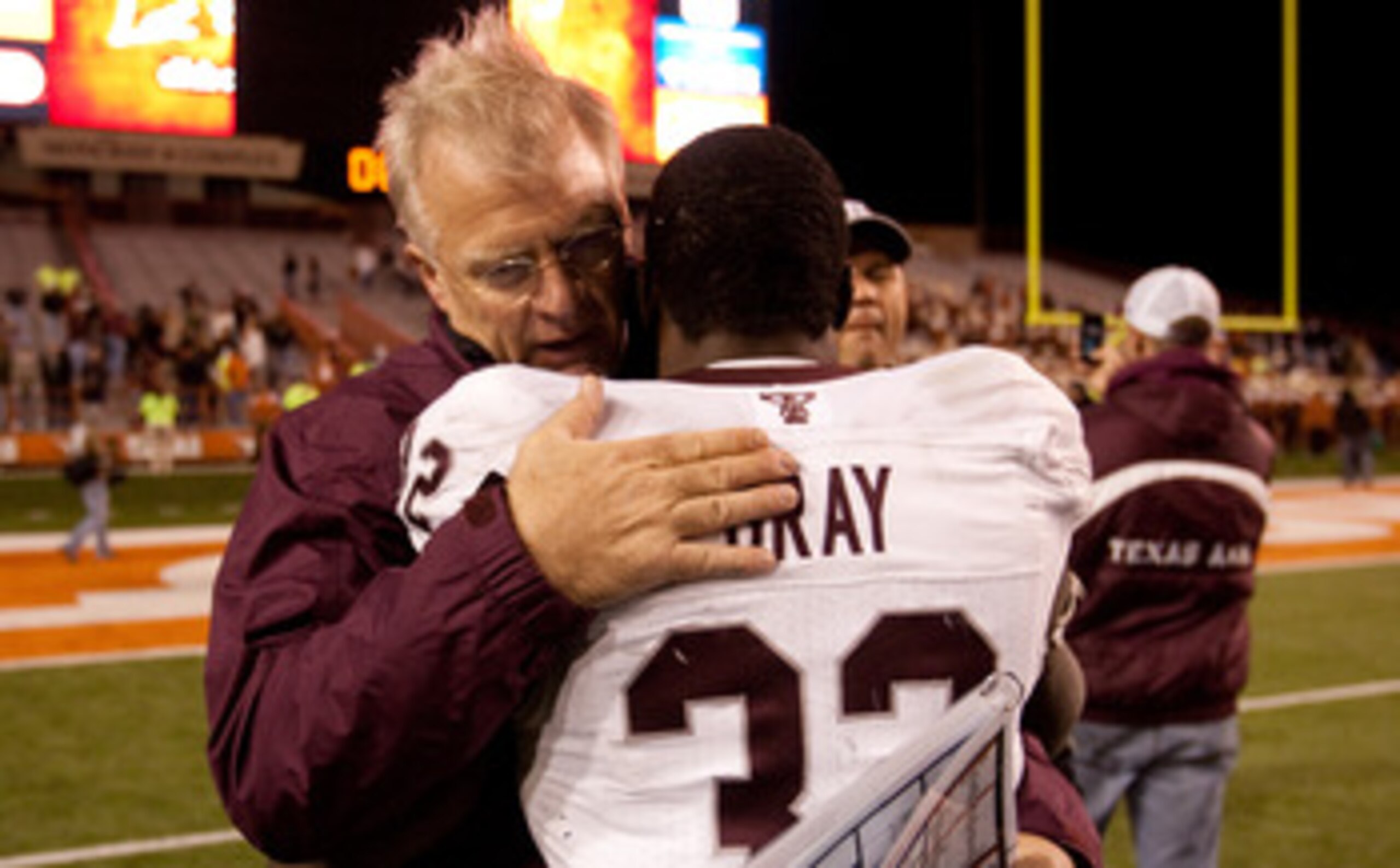 AUSTIN, TX - NOVEMBER 25:  Mike Sherman, head coach of Texas A&M, embraces running back Cyrus Gray #32 following Texas A&M's 24-17 win over The University of Texas at Darrell K. Royal-Texas Memorial Stadium on November 25, 2010 in Austin, Texas. (Photo by
