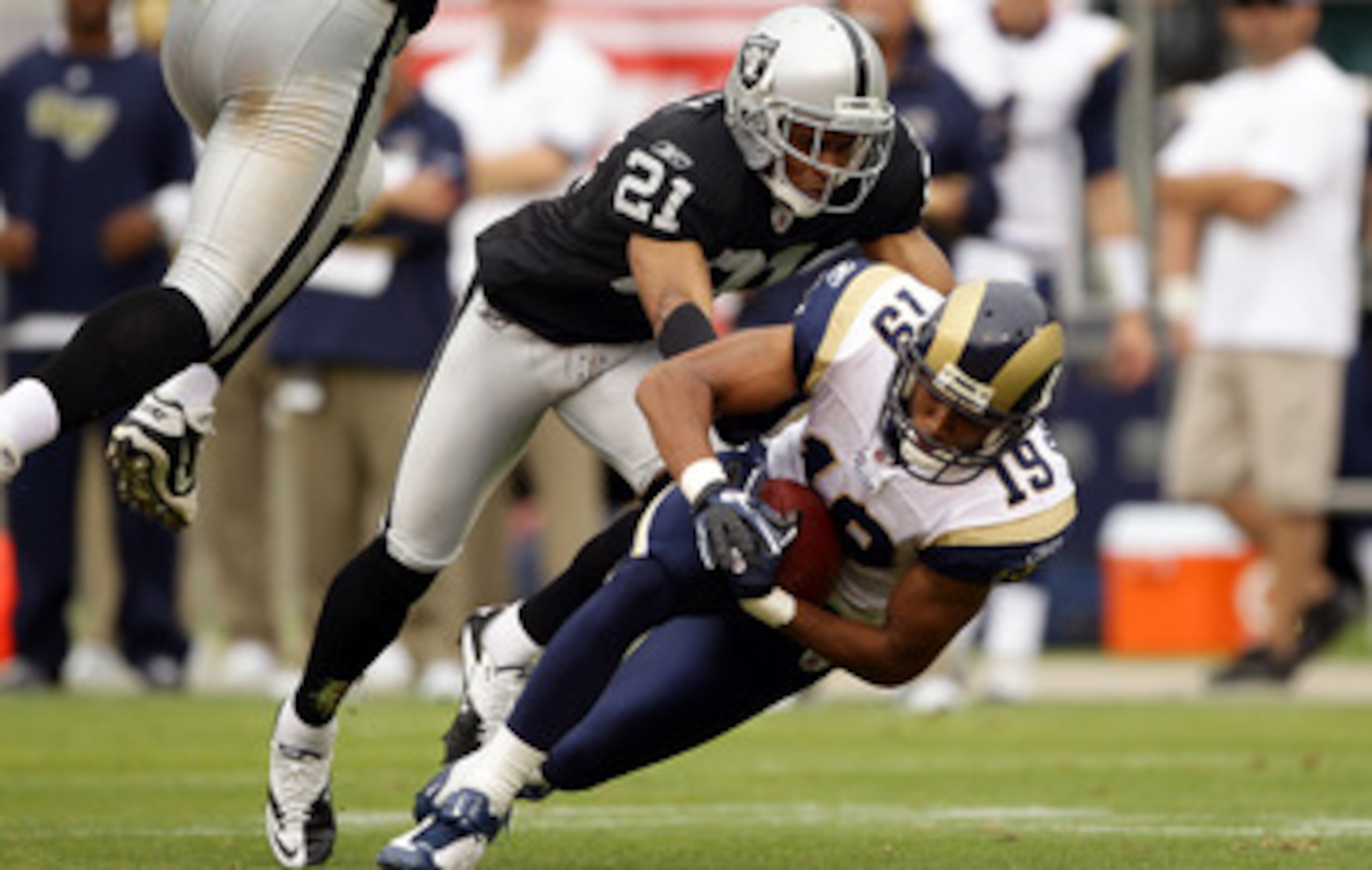OAKLAND, CA - SEPTEMBER 19:  Laurent Robinson #19 of the St. Louis Rams is tackled by Nnamdi Asomugha #21 of the Oakland Raiders at the Oakland-Alameda County Coliseum on September 19, 2010 in Oakland, California.  (Photo by Ezra Shaw/Getty Images)