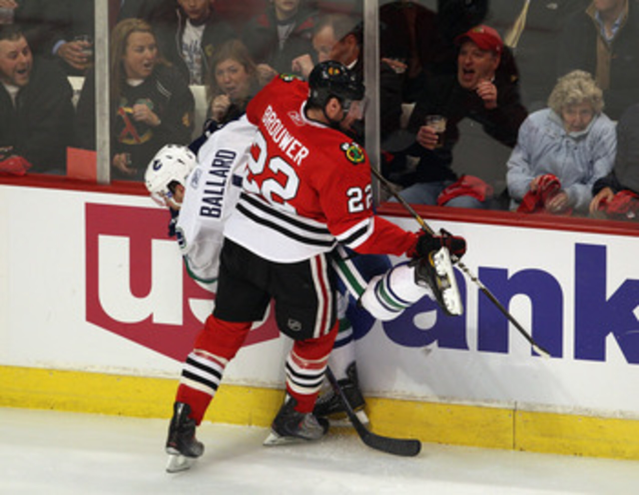 CHICAGO, IL - APRIL 19: Troy Brouwer #22 of the Chicago Blackhawks checks Keith Ballard #4 of the Vancouver Canucks in Game Four of the Western Conference Quarterfinals during the 2011 NHL Stanley Cup Playoffs at the United Center on April 19, 2011 in Chi