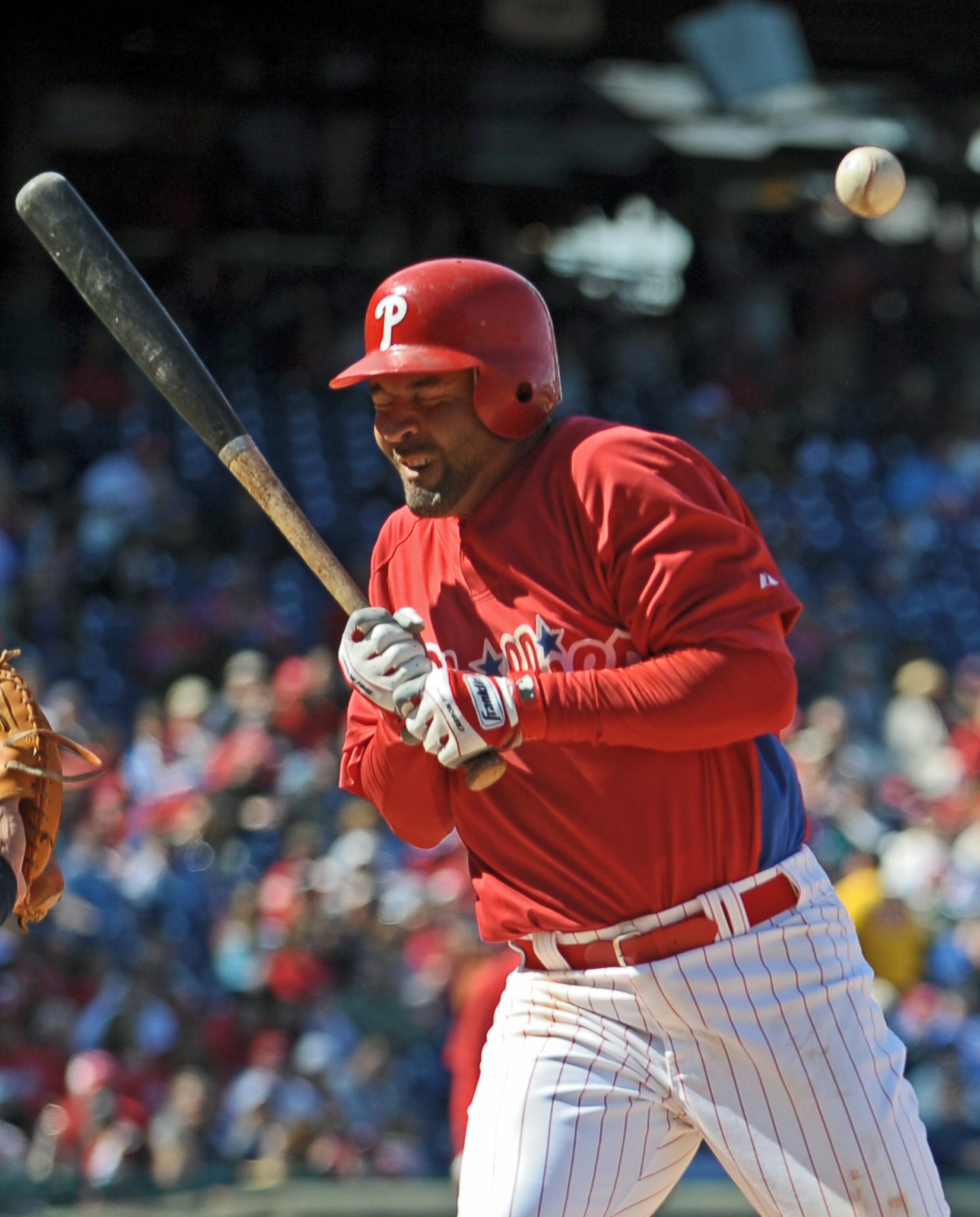 PHILADELPHIA - APRIL 4: Miguel Cairo #9 of the Philadelphia Phillies gets a hit by a pitch during the game against the Tampa Bay Rays on April 4, 2009 at Citizens Bank Park in Philadelphia, Pennsylvania.  The Rays won 9-7. (Photo by Drew Hallowell/Getty I