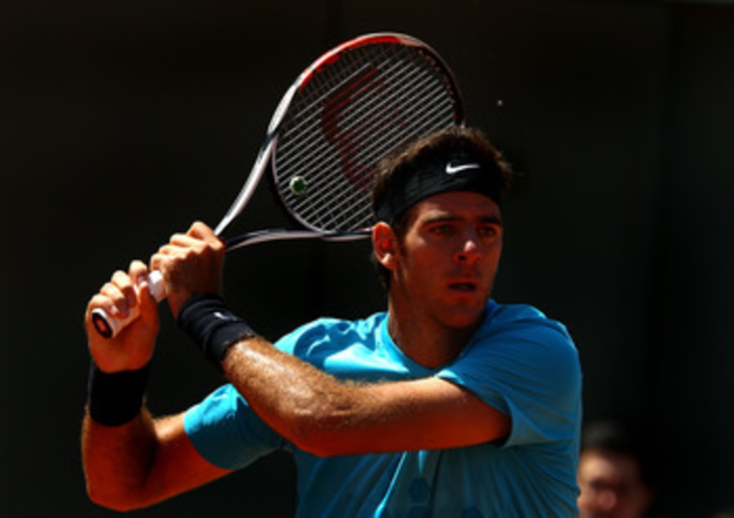 PARIS, FRANCE - MAY 23:  Juan Martin Del Potro of Argentina plays a backhand during the men's singles first round match between Juan Martin Del Potro of Argentina and Ivo Karlovic of Croatia on day two of the French Open at Roland Garros on May 23, 2011 i