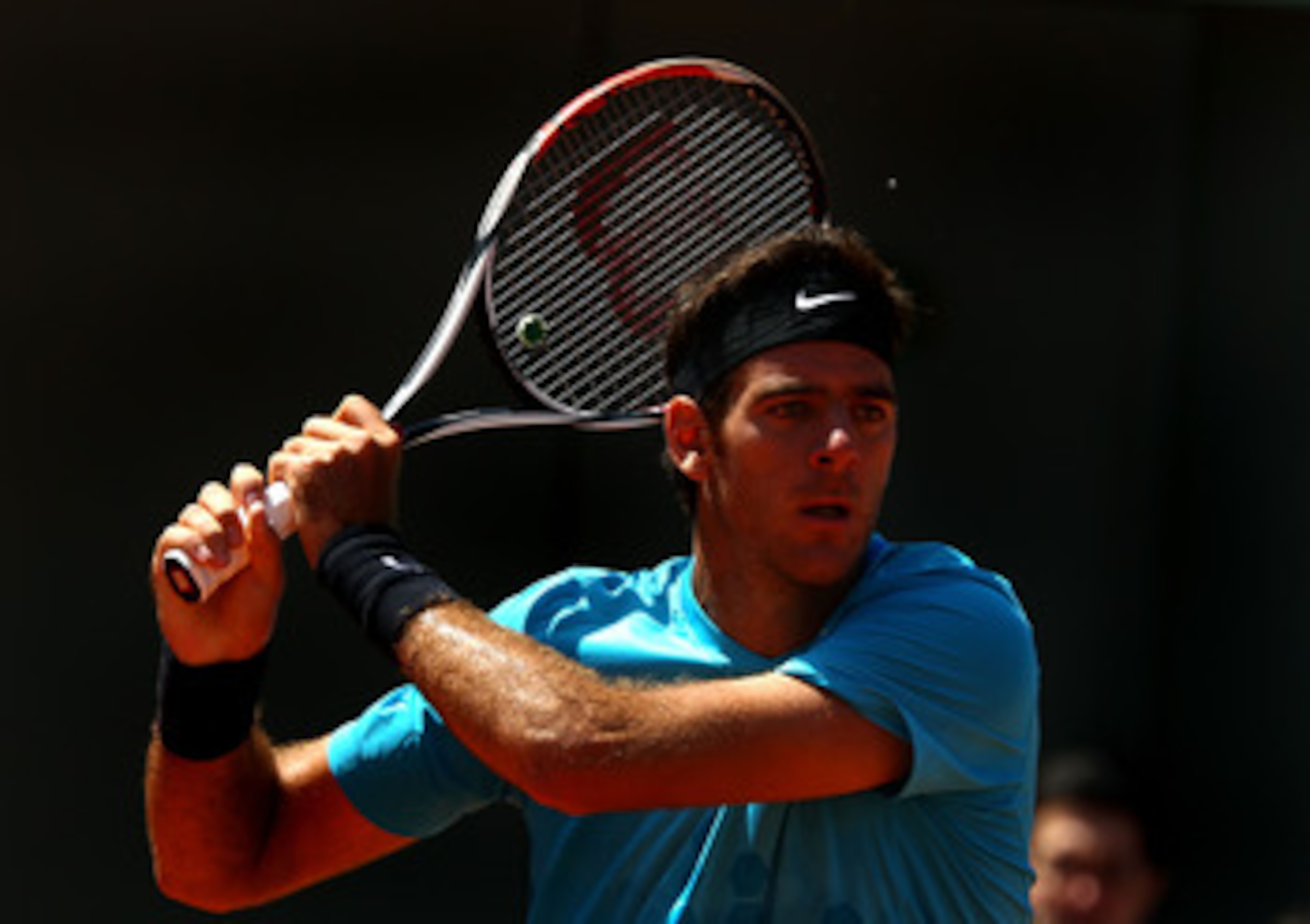 PARIS, FRANCE - MAY 23:  Juan Martin Del Potro of Argentina plays a backhand during the men's singles first round match between Juan Martin Del Potro of Argentina and Ivo Karlovic of Croatia on day two of the French Open at Roland Garros on May 23, 2011 i
