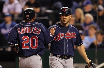 KANSAS CITY, MO - MAY 16:  Orlando Cabrera #20 of the Cleveland Indians is congratulated by Travis Hafner #48 after scoring during the game against the Kansas City Royals on May 16, 2011 at Kauffman Stadium in Kansas City, Missouri.  (Photo by Jamie Squir