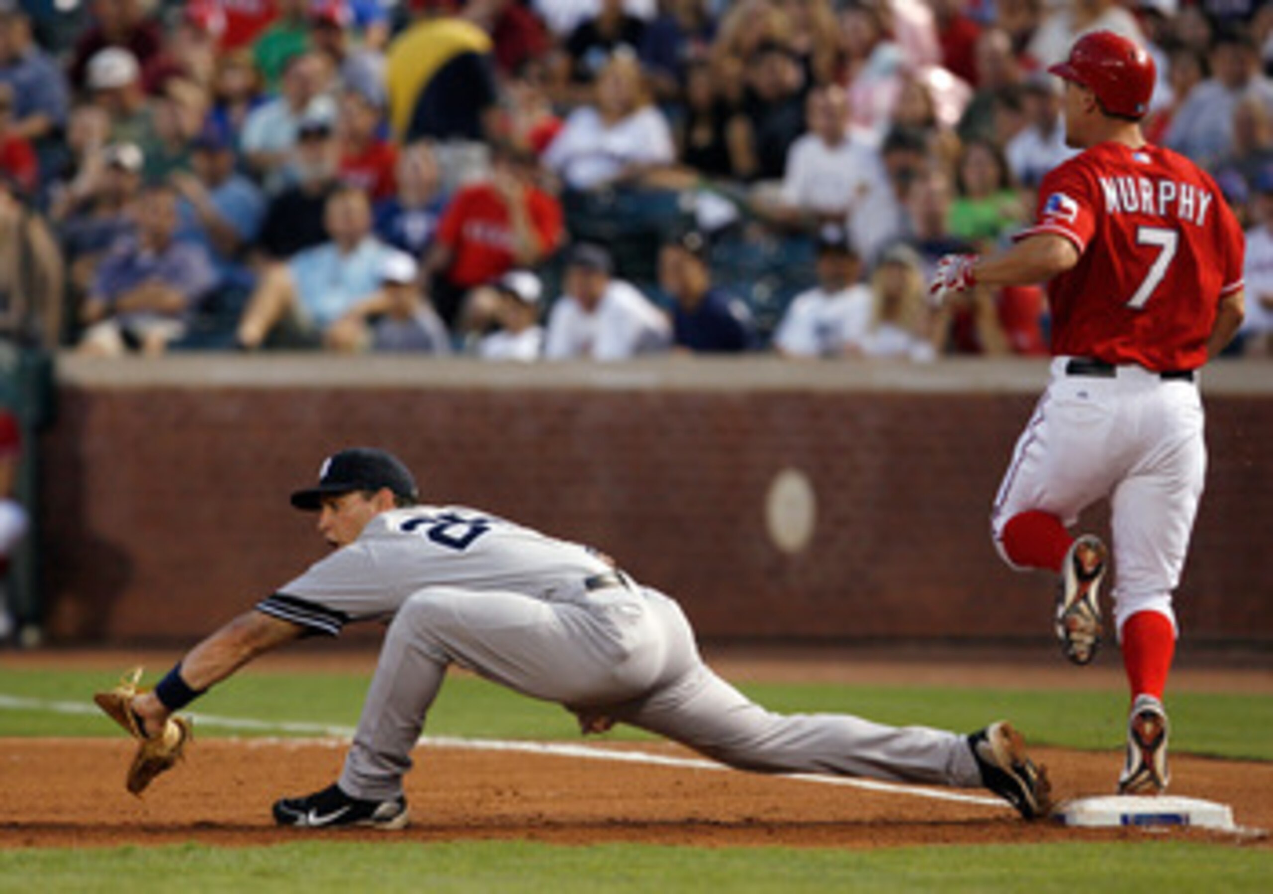 ARLINGTON, TX - SEPTEMBER 10: Baserunner David Murphy #7 of the Texas Rangers beats the throw against first baseman Mark Teixeria #25 of the New York Yankees on September 10, 2010 at Rangers Ballpark in Arlington, Texas. (Photo by Tom Pennington/Getty I ARLINGTON, TX - SEPTEMBER 10: Baserunner David Murphy #7 of the Texas Rangers beats the throw against first baseman Mark Teixeria #25 of the New York Yankees on September 10, 2010 at Rangers Ballpark in Arlington, Texas. (Photo by Tom Pennington/Getty I