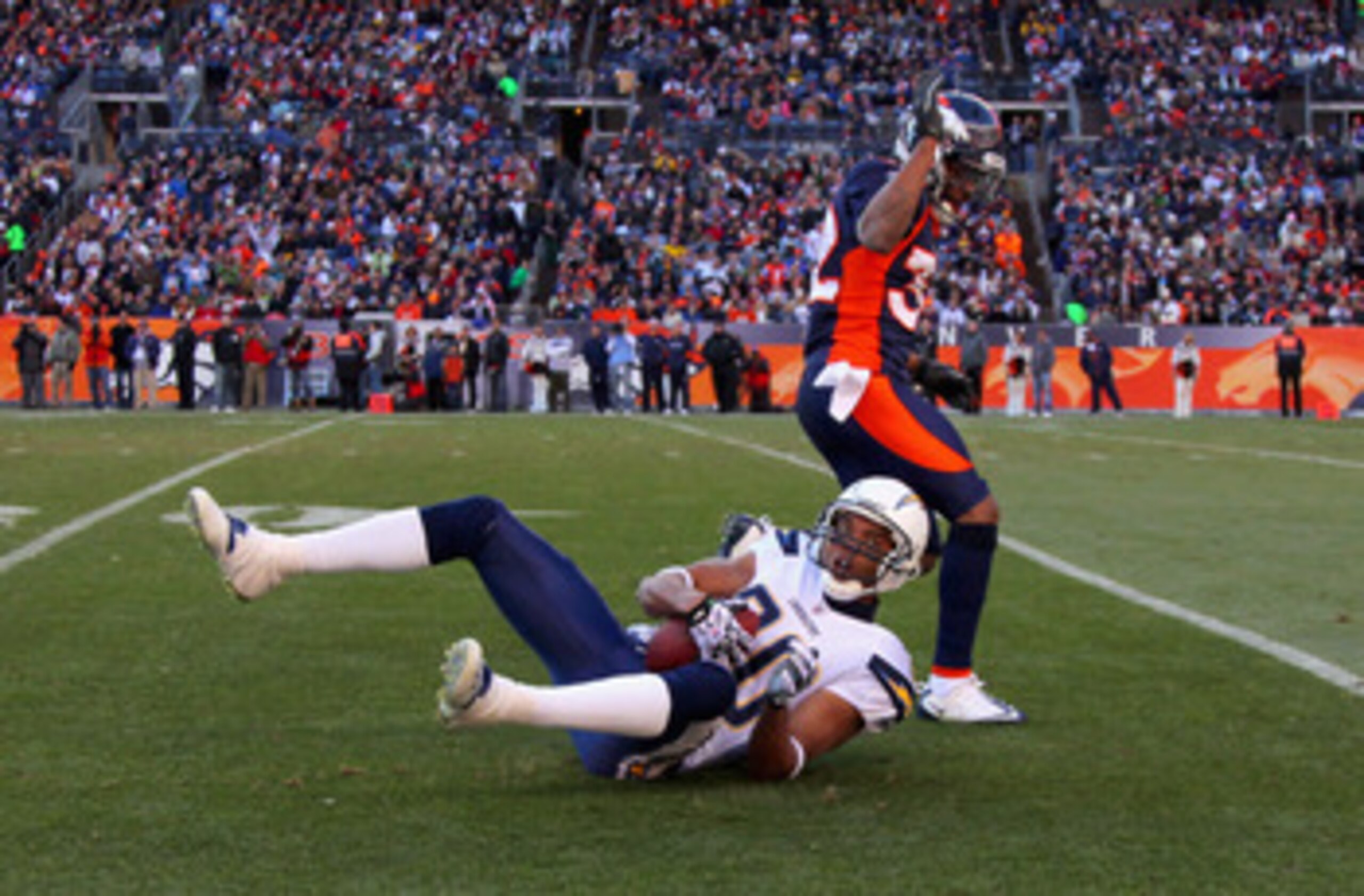 DENVER - JANUARY 02: Wide receiver Malcom Floyd #80 of the San Diego Chargers hangs on to the ball for a first down reception after Perrish Cox #32 of the Denver Broncos was called for pass interference at INVESCO Field at Mile High on January 2, 2011 in DENVER - JANUARY 02: Wide receiver Malcom Floyd #80 of the San Diego Chargers hangs on to the ball for a first down reception after Perrish Cox #32 of the Denver Broncos was called for pass interference at INVESCO Field at Mile High on January 2, 2011 in