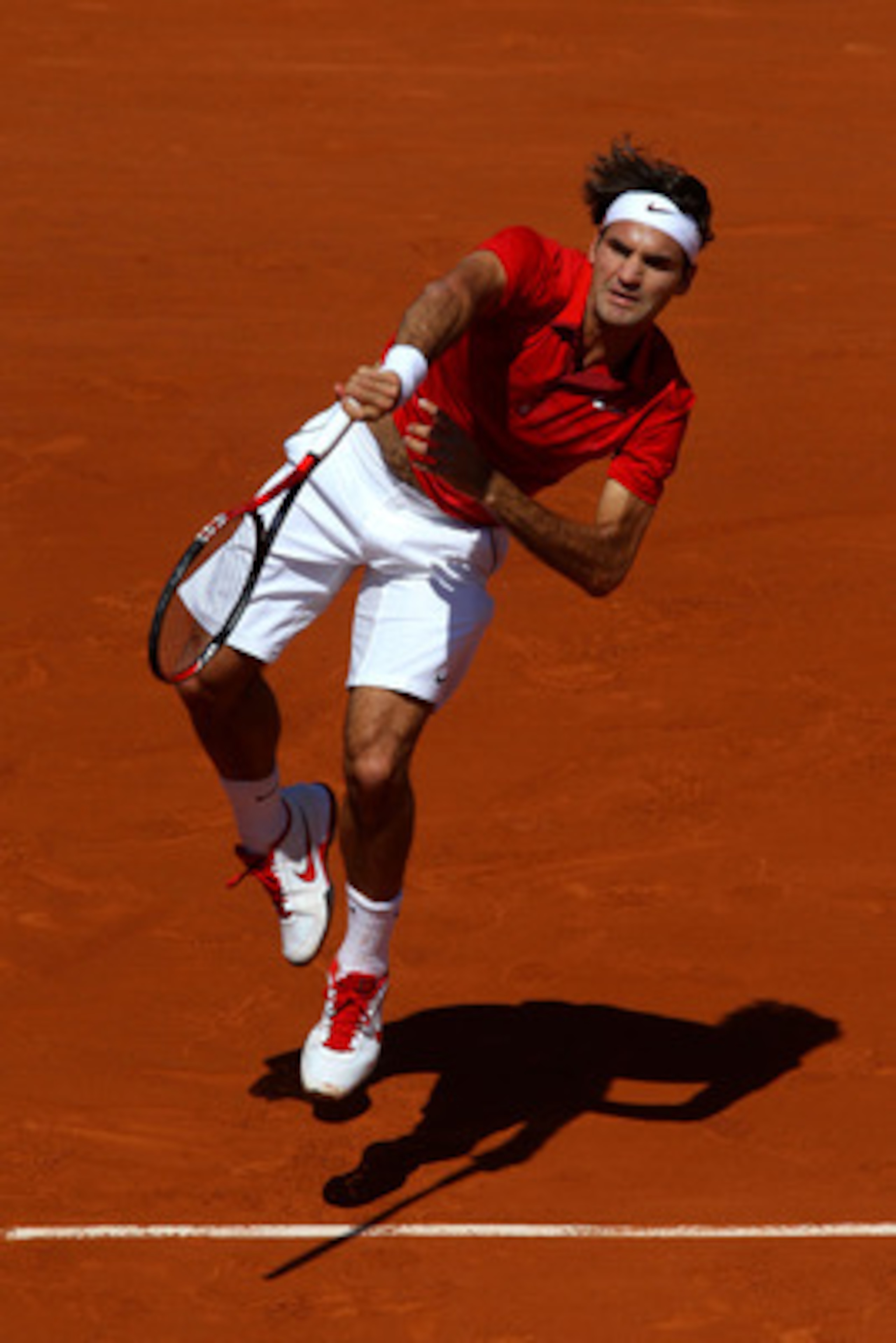 PARIS, FRANCE - MAY 23:  Roger Federer of Switzerland serves during the men's singles first round match between Feliciano Lopez of Spain and Roger Federer of Switzerland on day two of the French Open at Roland Garros on May 23, 2011 in Paris, France.  (Ph