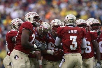 JACKSONVILLE, FL - JANUARY 01: Quarterback E.J. Manuel #3 of the Florida State Seminoles calls out a play in the huddle against the West Virginia Mountaineers during the Konica Minolta Gator Bowl on January 1, 2010 at Jacksonville Municipal Stadium in Ja JACKSONVILLE, FL - JANUARY 01: Quarterback E.J. Manuel #3 of the Florida State Seminoles calls out a play in the huddle against the West Virginia Mountaineers during the Konica Minolta Gator Bowl on January 1, 2010 at Jacksonville Municipal Stadium in Ja