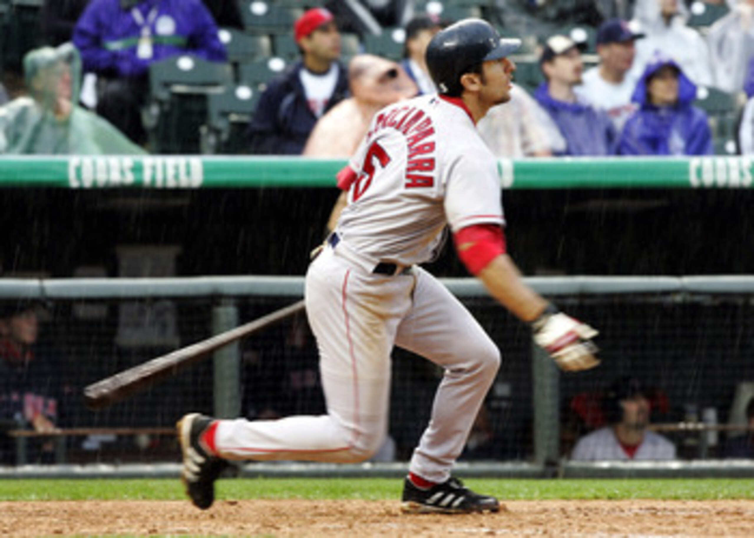 DENVER - JUNE 17:  Nomar Garciaparra #5 of the Boston Red Sox watches the path of a double against the Colorado Rockies in the seventh inning of a rainy game on June 17, 2004 at Coors Field in Denver, Colorado. Garciaparra had three hits in the Red Sox 11
