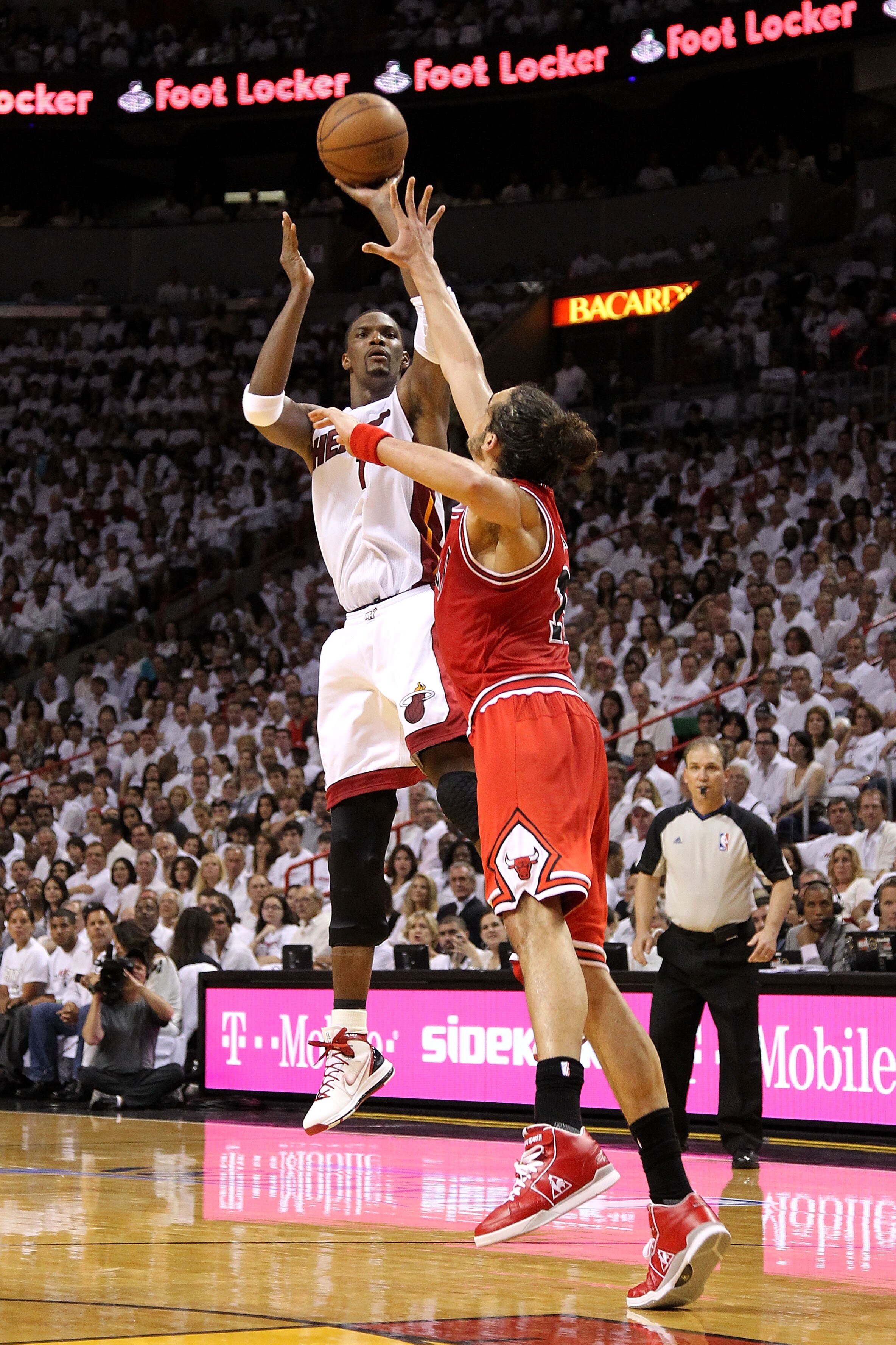 MIAMI, FL - MAY 22:  Chris Bosh #1 of the Miami Heat attempts a shot agaist Joakim Noah #13 of the Chicago Bulls in Game Three of the Eastern Conference Finals during the 2011 NBA Playoffs on May 22, 2011 at American Airlines Arena in Miami, Florida.  NOT