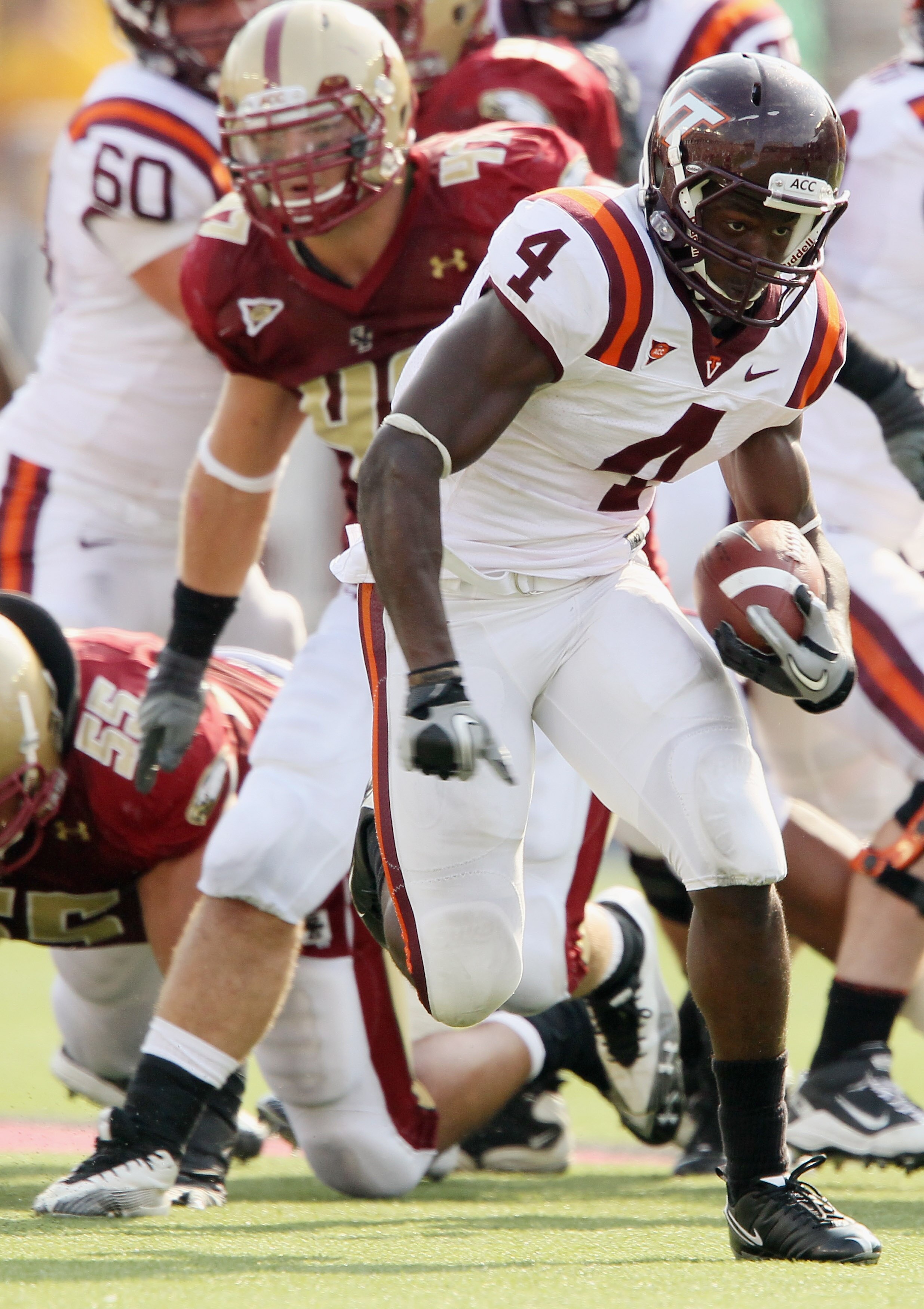 CHESTNUT HILL, MA - SEPTEMBER 25:  David Wilson #4  of the Virginia Tech Hokies breaks free and carries the ball as Brad Newman #47 of the Boston College Eagles defends on September 25, 2010 at Alumni Stadium in Chestnut Hill, Massachusetts. Virginia Tech