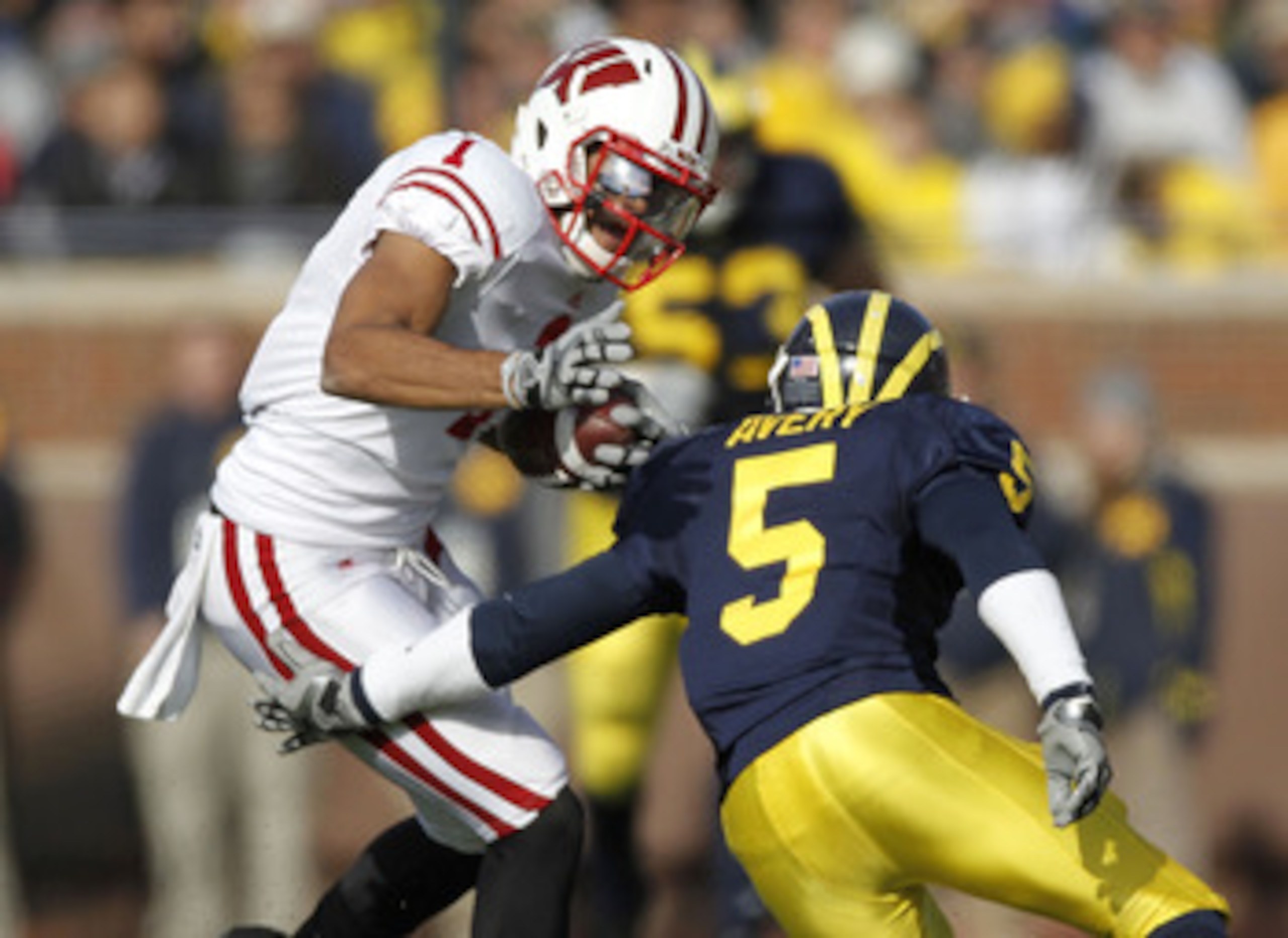 ANN ARBOR, MI - NOVEMBER 20: Nick Toon #1 of the Wisconsin Badgers tries to get around the tackle of Courtney Avery #5 of the Michigan Wolverines at Michigan Stadium on November 20, 2010 in Ann Arbor, Michigan. (Photo by Gregory Shamus/Getty Images) ANN ARBOR, MI - NOVEMBER 20: Nick Toon #1 of the Wisconsin Badgers tries to get around the tackle of Courtney Avery #5 of the Michigan Wolverines at Michigan Stadium on November 20, 2010 in Ann Arbor, Michigan. (Photo by Gregory Shamus/Getty Images)