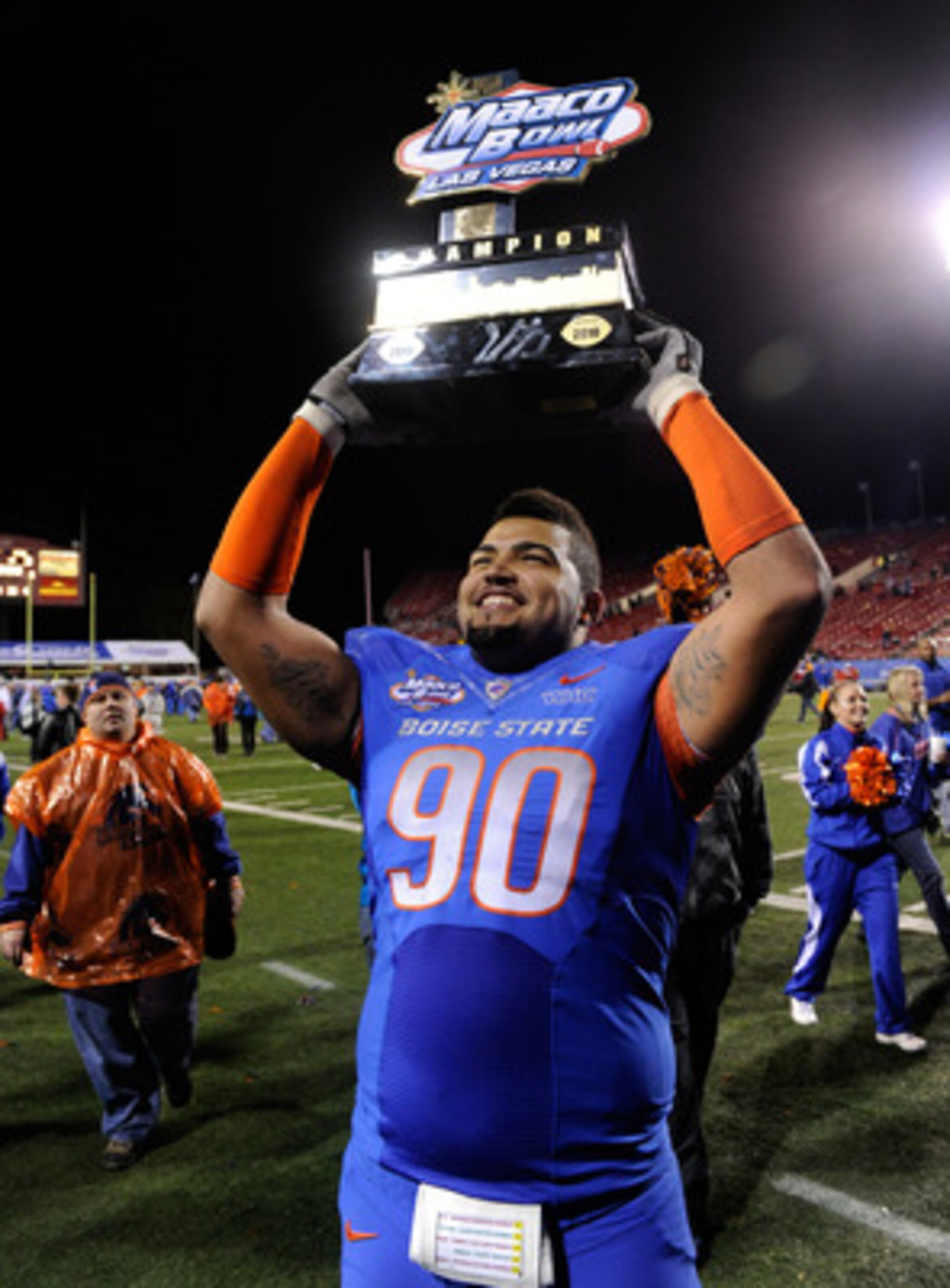 LAS VEGAS, NV - DECEMBER 22:  Billy Winn #90 of the Boise State Broncos holds up a trophy as he celebrates the team's 26-3 victory over the Utah Utes in the MAACO Bowl Las Vegas at Sam Boyd Stadium December 22, 2010 in Las Vegas, Nevada.  (Photo by Ethan
