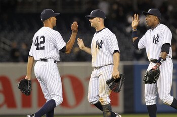 NEW YORK, NY - APRIL 02:  Mariano Rivera #42 of the New York Yankees celebrates the win with teammates Brett Gardner #11 and Curtis Granderson #14  against the Detroit Tigers at Yankee Stadium on April 2, 2011 in the Bronx borough of New York City.  (Phot