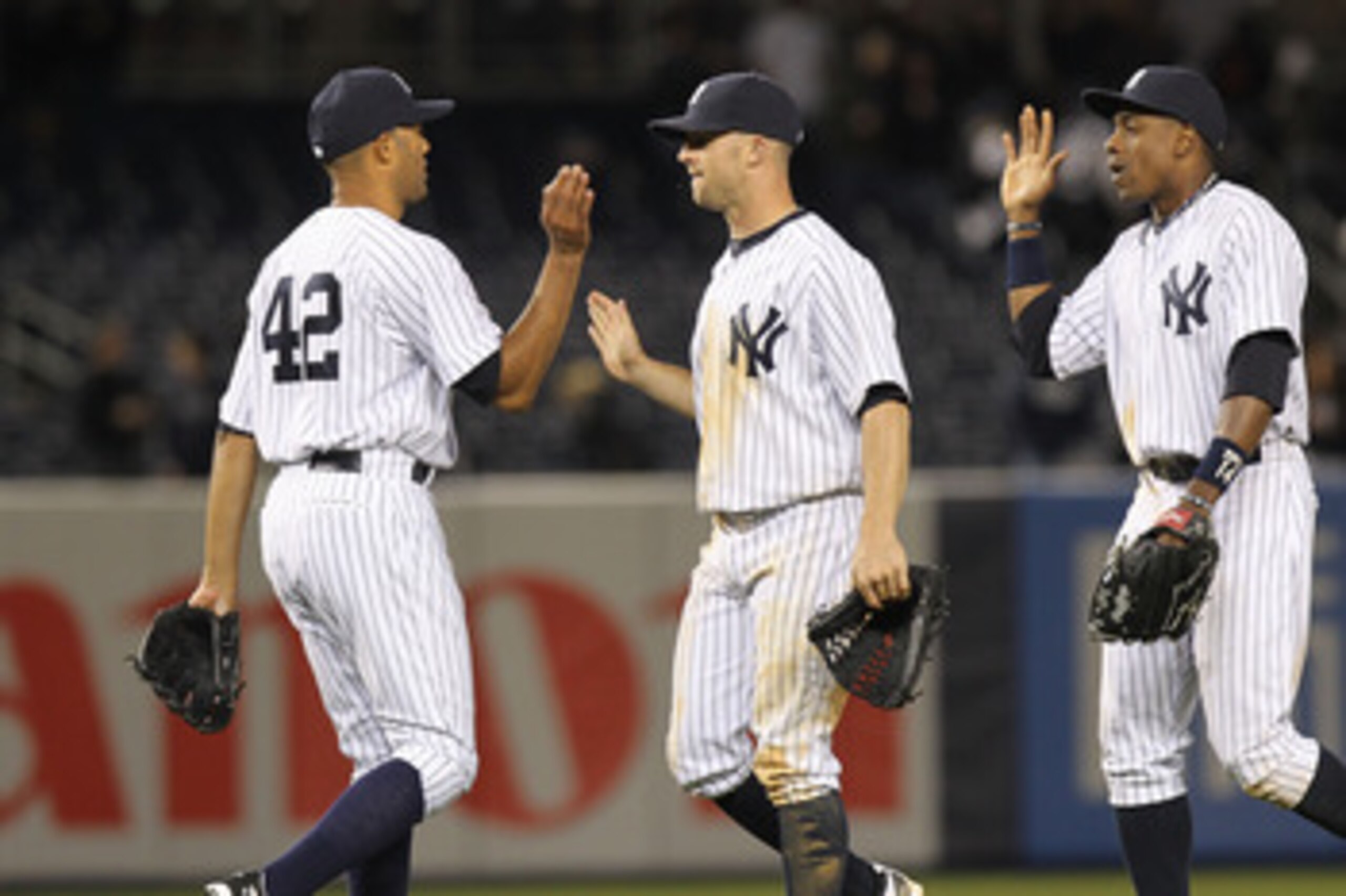 NEW YORK, NY - APRIL 02:  Mariano Rivera #42 of the New York Yankees celebrates the win with teammates Brett Gardner #11 and Curtis Granderson #14  against the Detroit Tigers at Yankee Stadium on April 2, 2011 in the Bronx borough of New York City.  (Phot