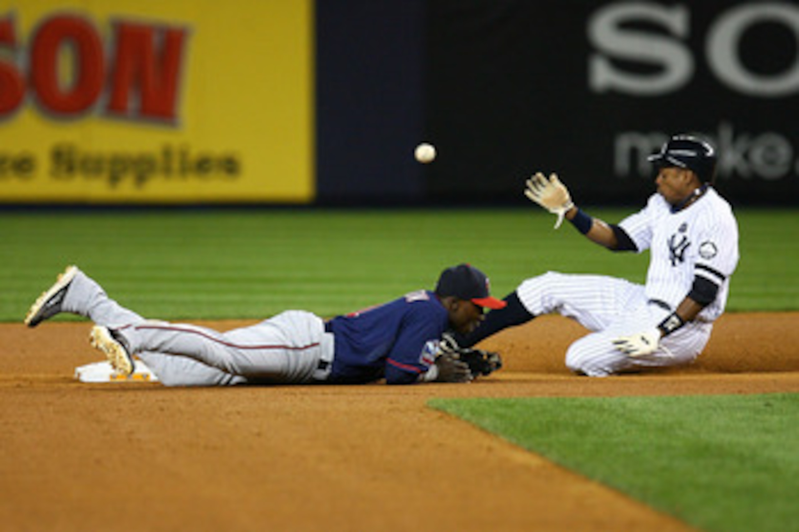 NEW YORK - OCTOBER 09:  Curtis Granderson #14 of the New York Yankees safely steals second base against Orlando Hudson #1 of the Minnesota Twins during the bottom of the fourth inning of Game Three of the ALDS part of the 2010 MLB Playoffs at Yankee Stadi