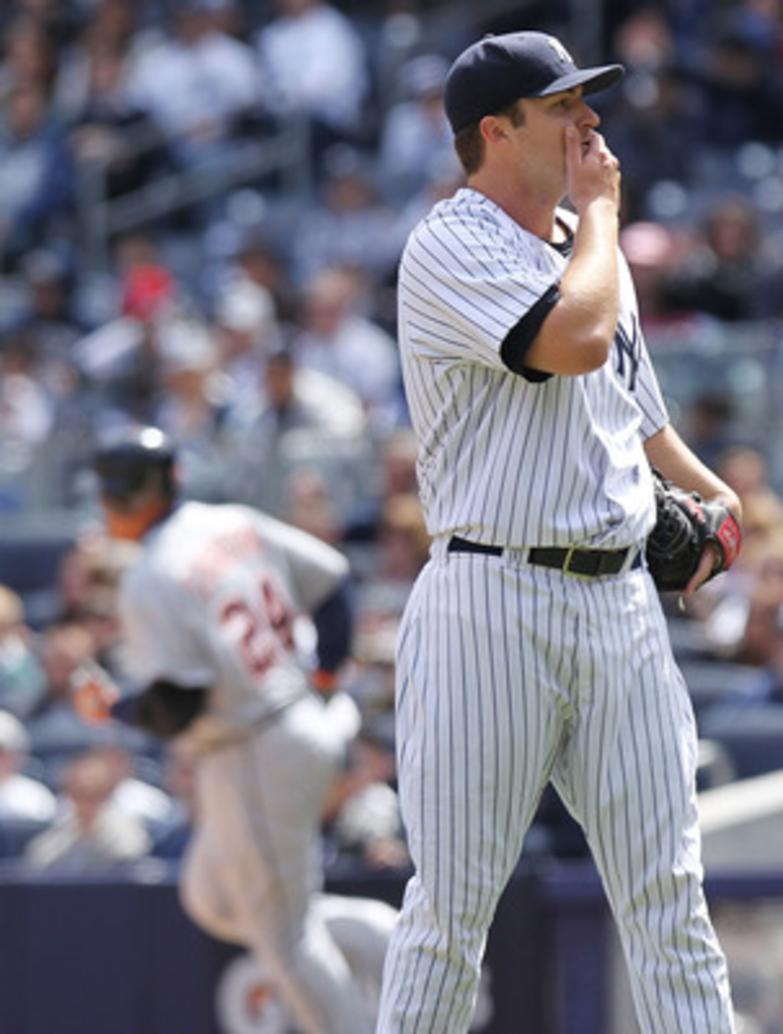 NEW YORK, NY - APRIL 03:  Phil Hughes #65 of the New York Yankees reacts after Miguel Cabrera #24 of the Detroit Tigers rounds the bases on a two run home run at Yankee Stadium on April 3, 2011 in the Bronx borough of New York City.  (Photo by Nick Laham/