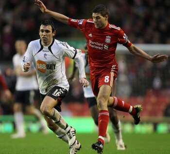 LIVERPOOL, ENGLAND - JANUARY 01:  Steven Gerrard of Liverpool competes for the ball with Mark Davies of Bolton Wanderers during the Barclays Premier League match between Liverpool and Bolton Wanderers at Anfield on January 1, 2011 in Liverpool, England.  