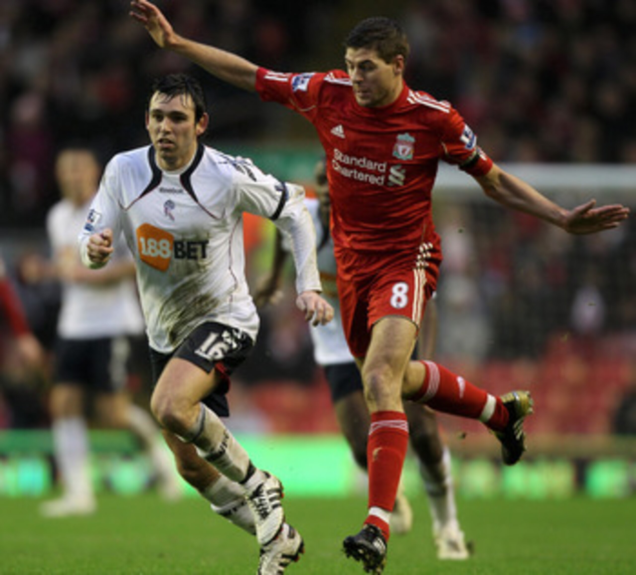LIVERPOOL, ENGLAND - JANUARY 01:  Steven Gerrard of Liverpool competes for the ball with Mark Davies of Bolton Wanderers during the Barclays Premier League match between Liverpool and Bolton Wanderers at Anfield on January 1, 2011 in Liverpool, England.  