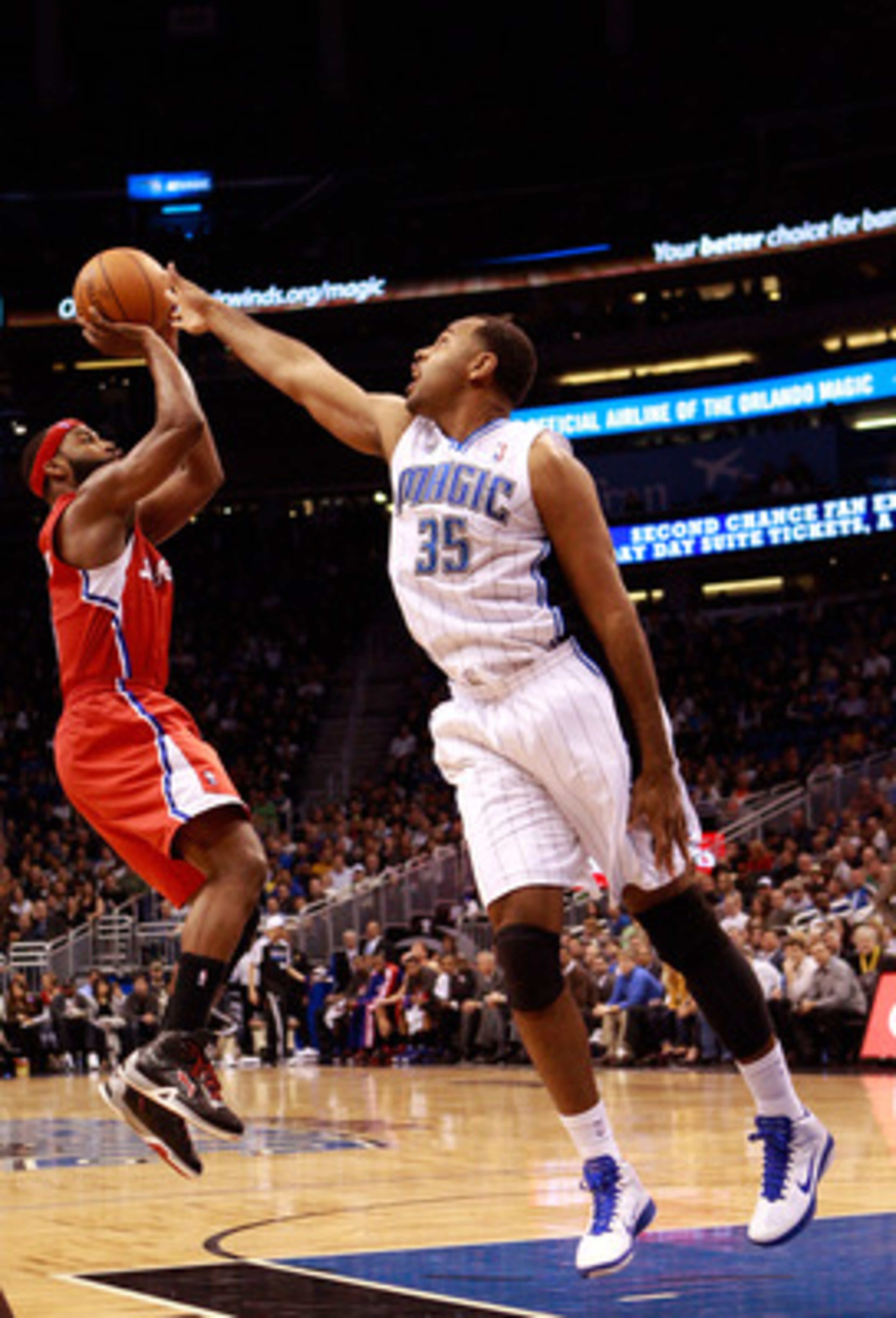 ORLANDO, FL - FEBRUARY 08:  Baron Davis #5 of the Los Angeles Clippers attempts a shot against Malik Allen #35 of the Orlando Magic during the game at Amway Arena on February 8, 2011 in Orlando, Florida.  NOTE TO USER: User expressly acknowledges and agre