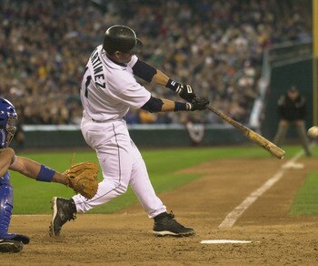 SEATTLE - APRIL 13:  Designated hitter Edgar Martinez #11 of the Seattle Mariners makes contact with the ball during the game against the Texas Rangers at Safeco Field on April 13, 2003 in Seattle Washington.  The Mariners defeated the Rangers 4-3 in extr