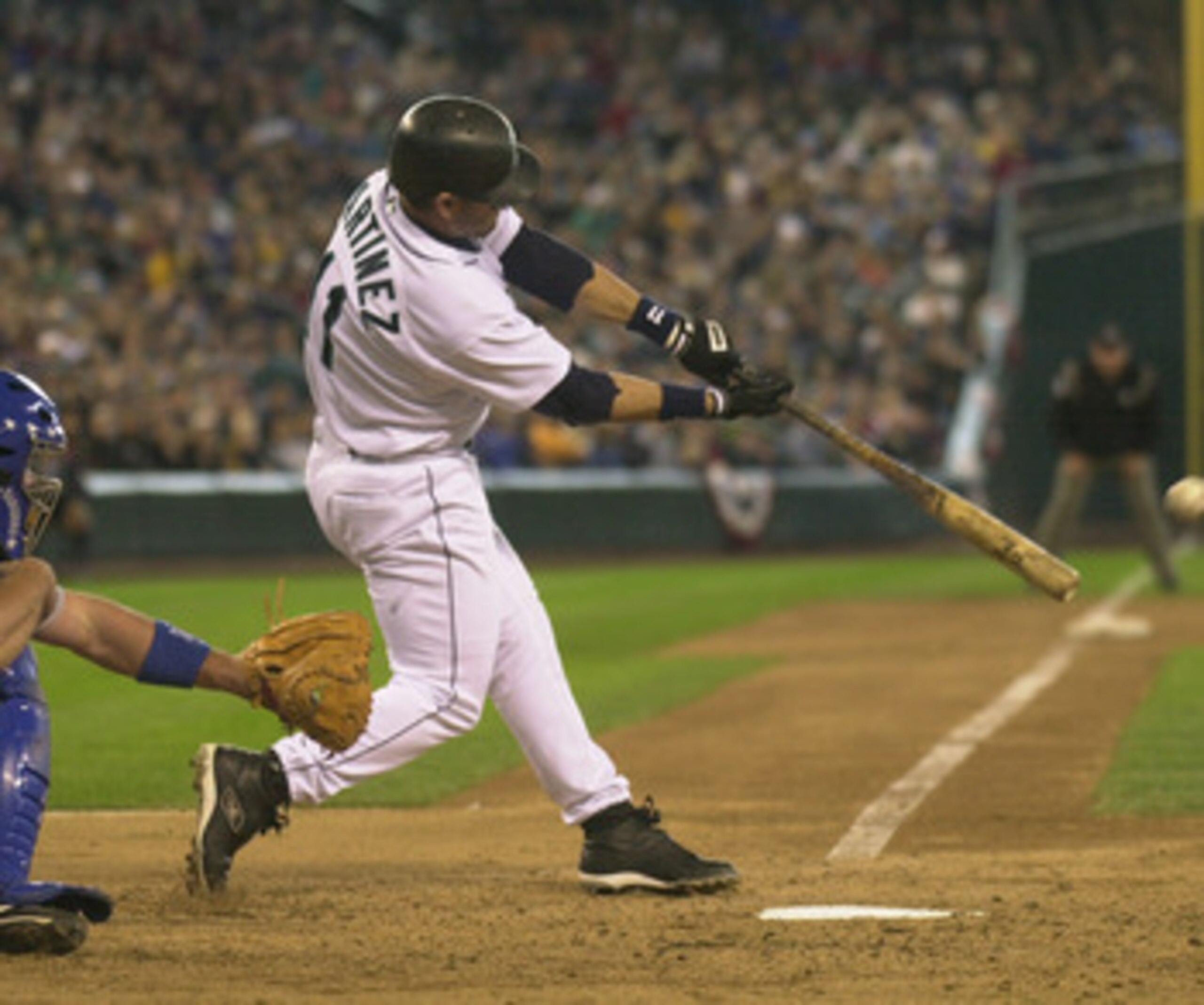 SEATTLE - APRIL 13: Designated hitter Edgar Martinez #11 of the Seattle Mariners makes contact with the ball during the game against the Texas Rangers at Safeco Field on April 13, 2003 in Seattle Washington. The Mariners defeated the Rangers 4-3 in extr SEATTLE - APRIL 13: Designated hitter Edgar Martinez #11 of the Seattle Mariners makes contact with the ball during the game against the Texas Rangers at Safeco Field on April 13, 2003 in Seattle Washington. The Mariners defeated the Rangers 4-3 in extr