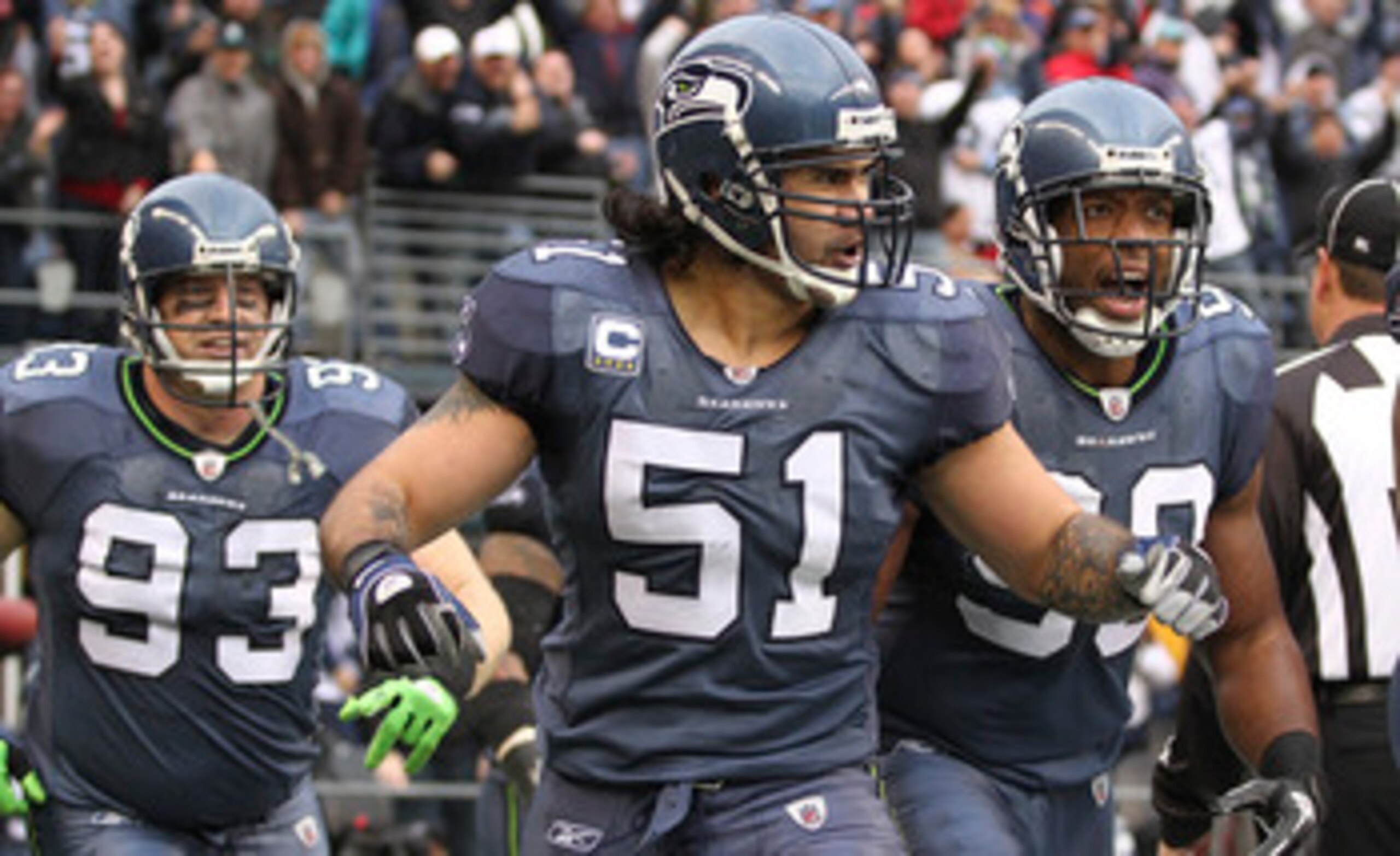 SEATTLE, WA - DECEMBER 05: Linebacker Lofa Tatupu #51 of the Seattle Seahawks celebrates with Jay Richardson #99 and Craig Terrill #93 after returning an interception for a touchdown against the Carolina Panthers at Qwest Field on December 5, 2010 in Sea SEATTLE, WA - DECEMBER 05: Linebacker Lofa Tatupu #51 of the Seattle Seahawks celebrates with Jay Richardson #99 and Craig Terrill #93 after returning an interception for a touchdown against the Carolina Panthers at Qwest Field on December 5, 2010 in Sea