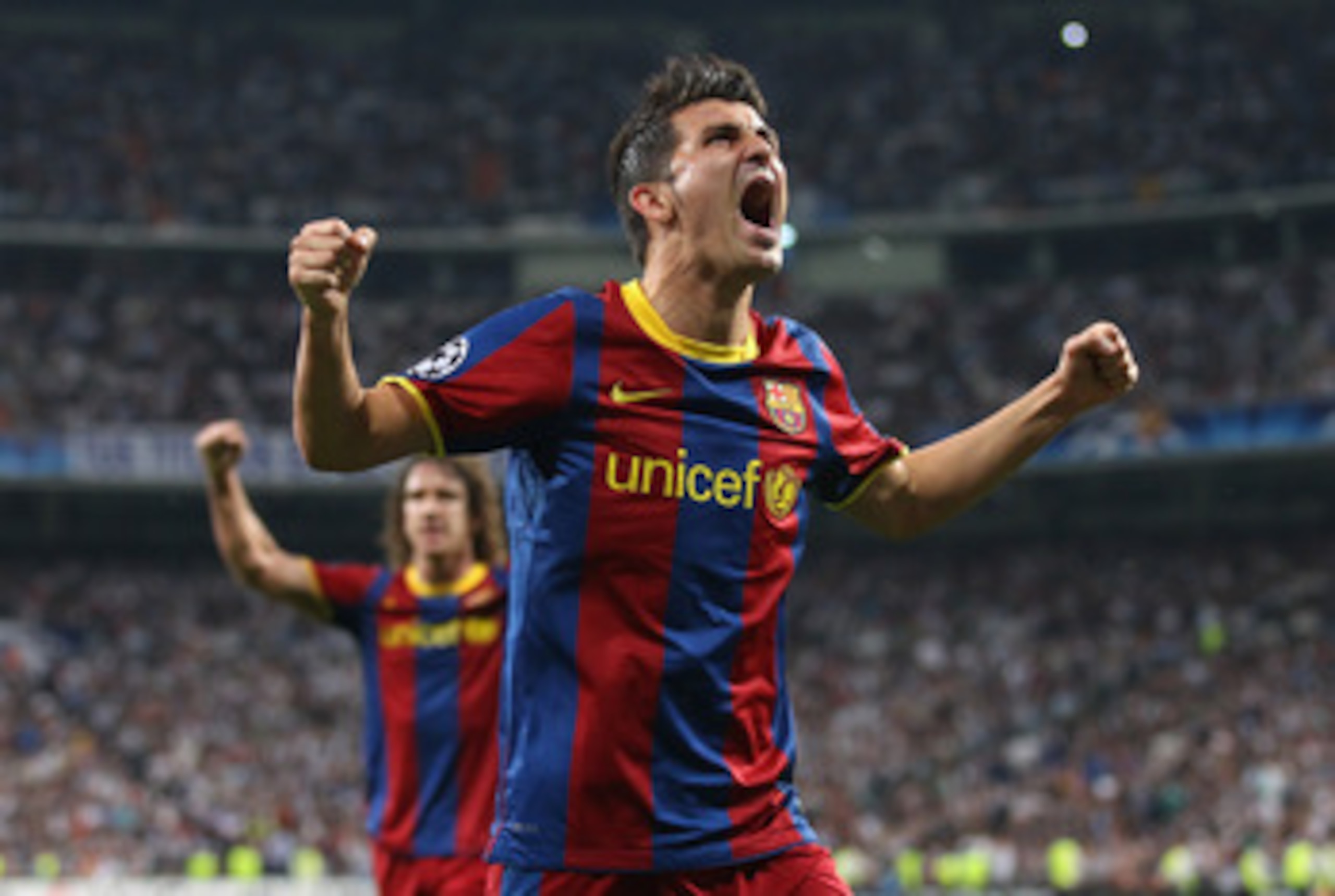 MADRID, SPAIN - APRIL 27:  David Villa of Barcelona celebrates after Lionel Messi scores the opening goal during the UEFA Champions League Semi Final first leg match between Real Madrid and Barcelona at Estadio Santiago Bernabeu on April 27, 2011 in Madri