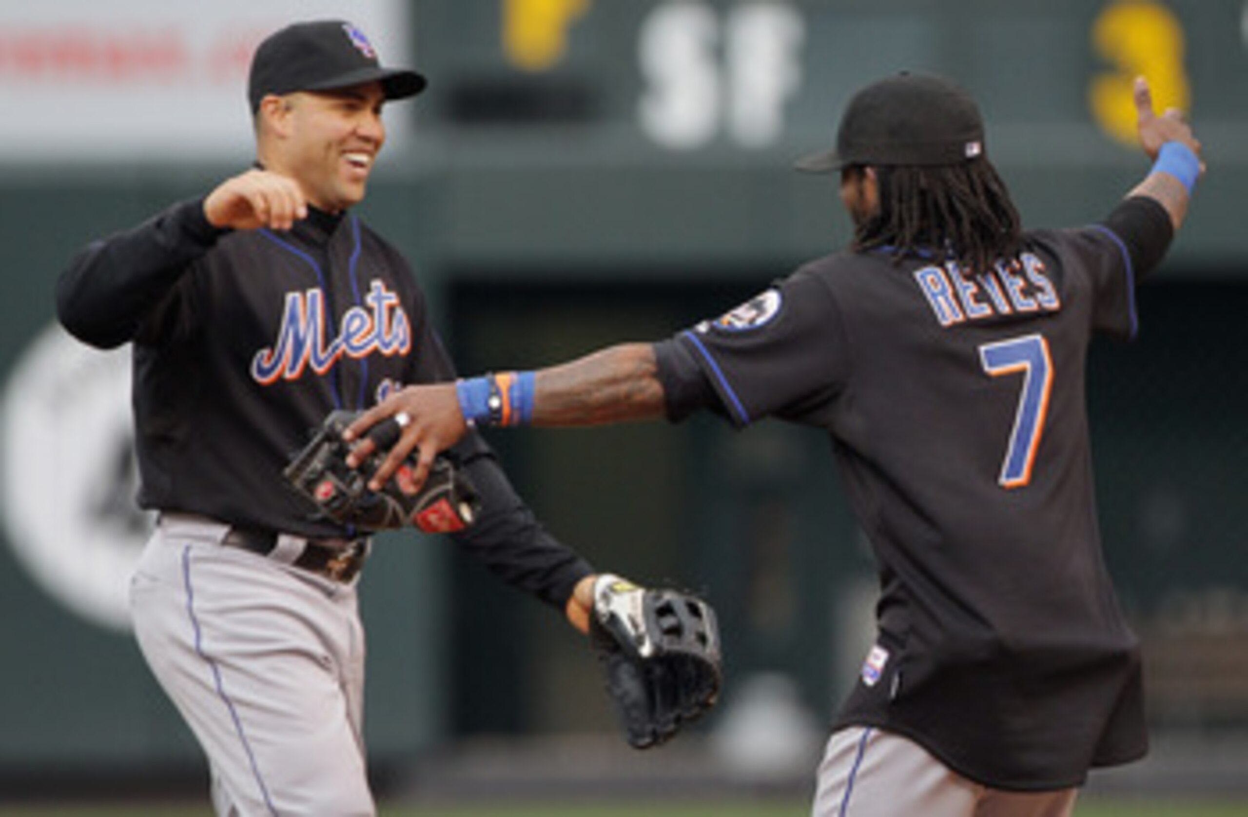 DENVER, CO - MAY 12:  Carlos Beltran #15 and Jose Reyes #7 of the New York Mets celebrate their 9-5 victory over the Colorado Rockies at Coors Field on May 12, 2011 in Denver, Colorado.  (Photo by Doug Pensinger/Getty Images)