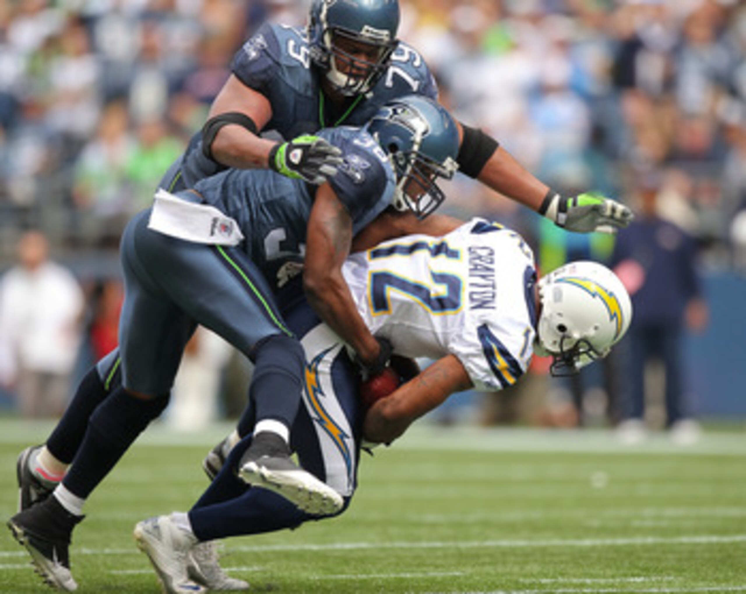 SEATTLE - SEPTEMBER 26: Wide receiver Patrick Crayton #12 of the San Diego Chargers is tackled by Lawyer Milloy #36 and Red Bryant #79 of the Seattle Seahawks at Qwest Field on September 26, 2010 in Seattle, Washington. (Photo by Otto Greule Jr/Getty Ima SEATTLE - SEPTEMBER 26: Wide receiver Patrick Crayton #12 of the San Diego Chargers is tackled by Lawyer Milloy #36 and Red Bryant #79 of the Seattle Seahawks at Qwest Field on September 26, 2010 in Seattle, Washington. (Photo by Otto Greule Jr/Getty Ima